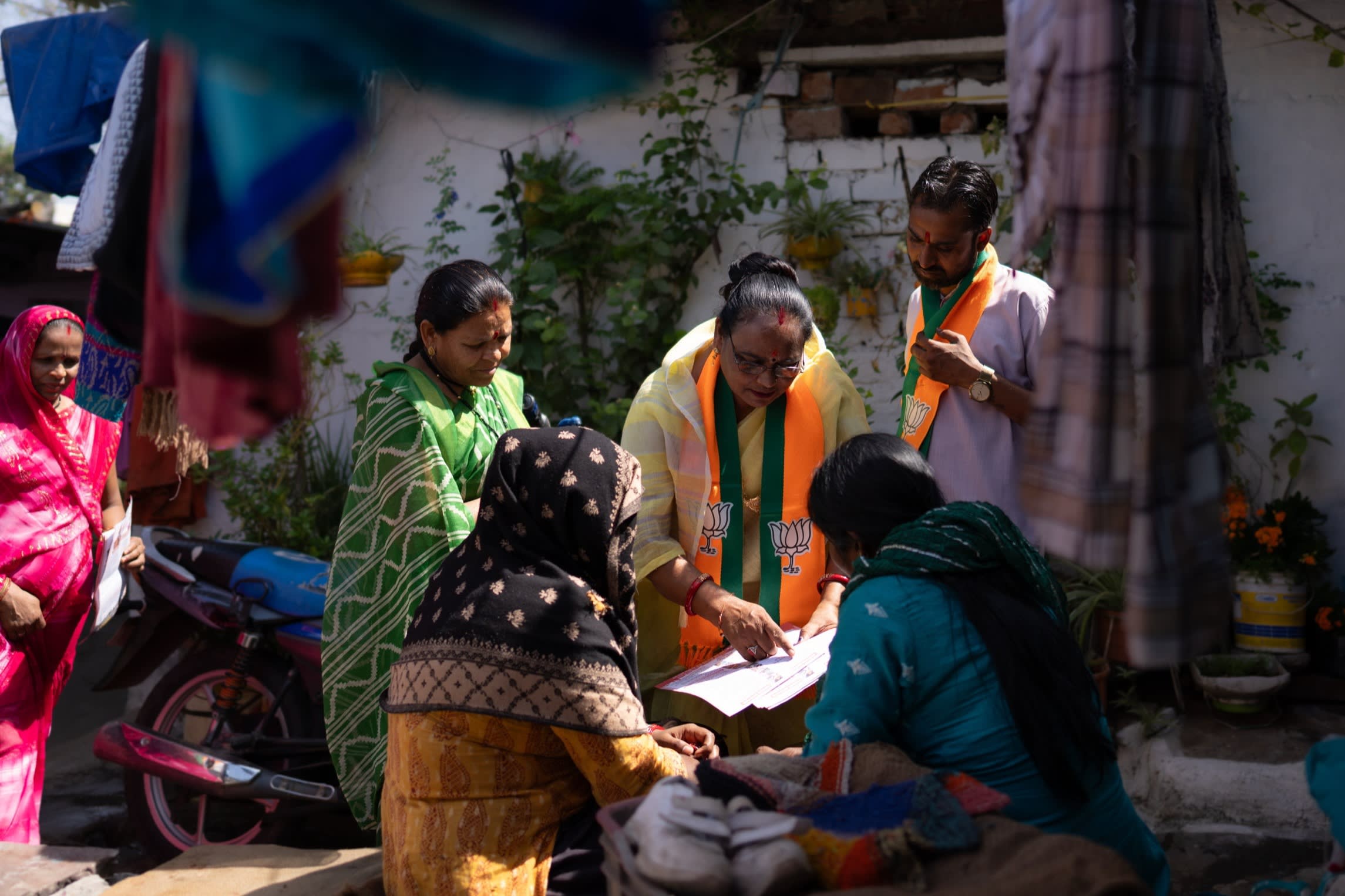The BJP activists speak to local women in Bhopal. Election data shows how a sharp shift in support among women and lower caste groups towards the BJP helped propel the party to an electoral majority