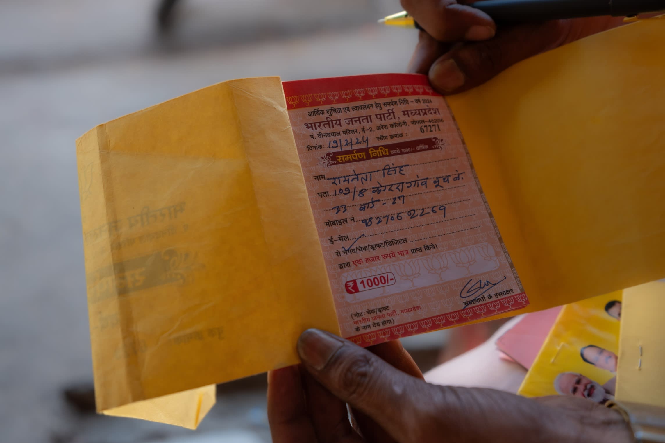 Shrivastava holds up a receipt for a donation to the BJP. While most of the party’s donations come from big business, it actively deploys its grassroots network to court small donors 