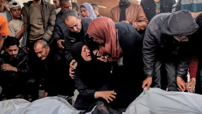 People mourn the deaths of relatives killed by an Israeli bombardment, at Al-Najjar hospital in Rafah in the southern Gaza Strip on April 16