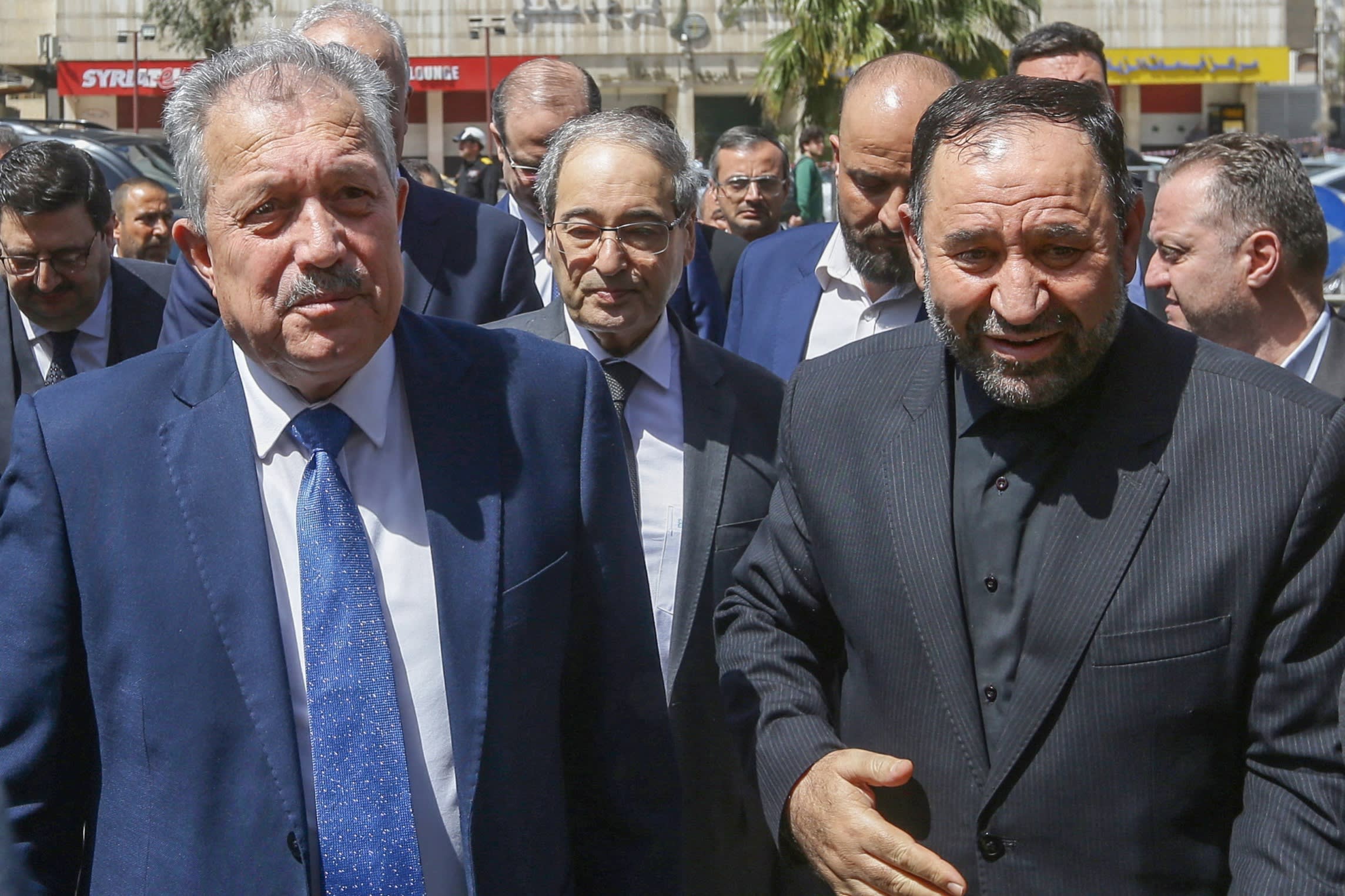 Iran’s ambassador to Syria Hossein Akbari, right, receives Syria’s Prime Minister Hussein Arnous, left, and foreign minister Faisal Miqdad, centre, at the Iranian embassy in Damascus