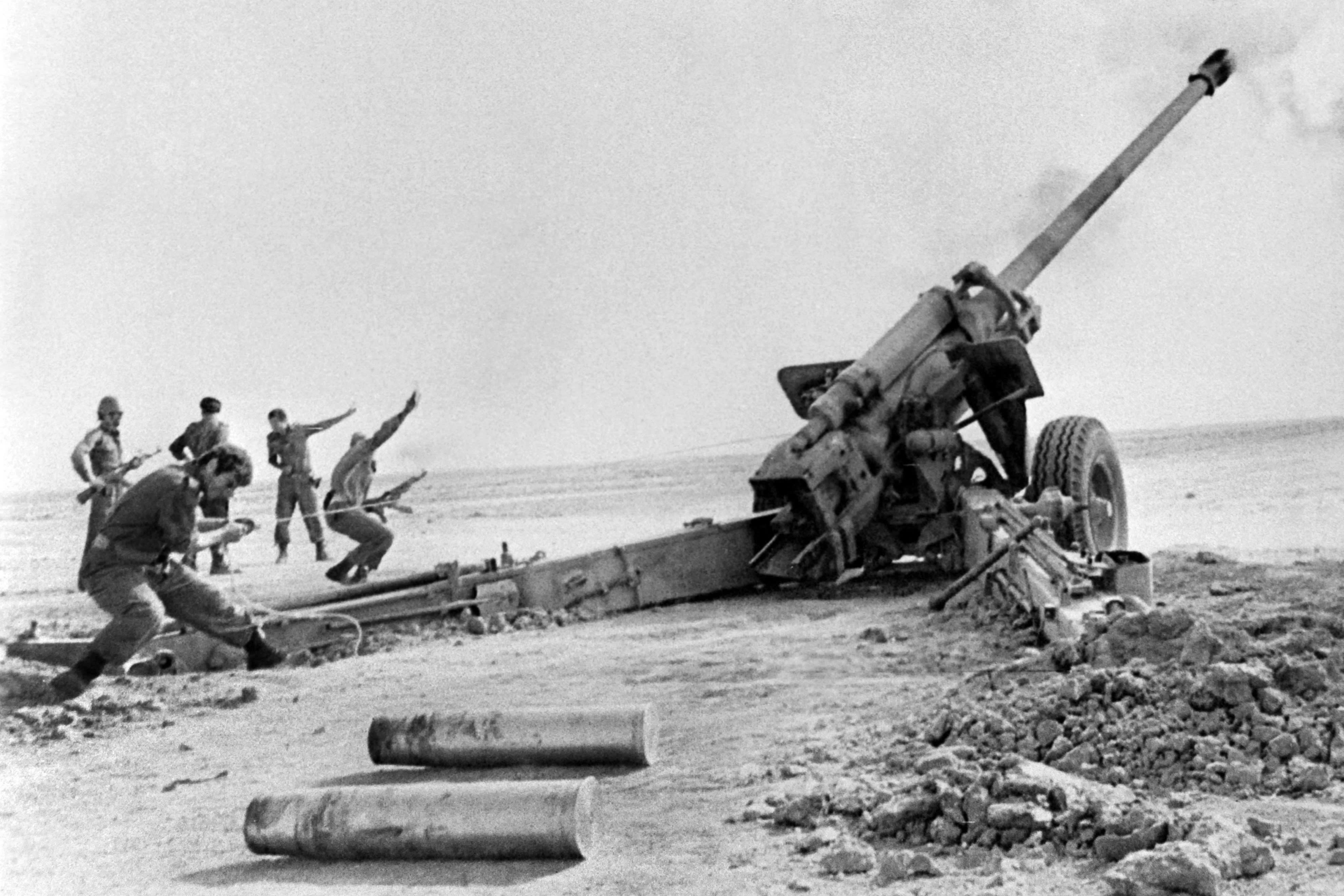 Soldiers firing artillery shells