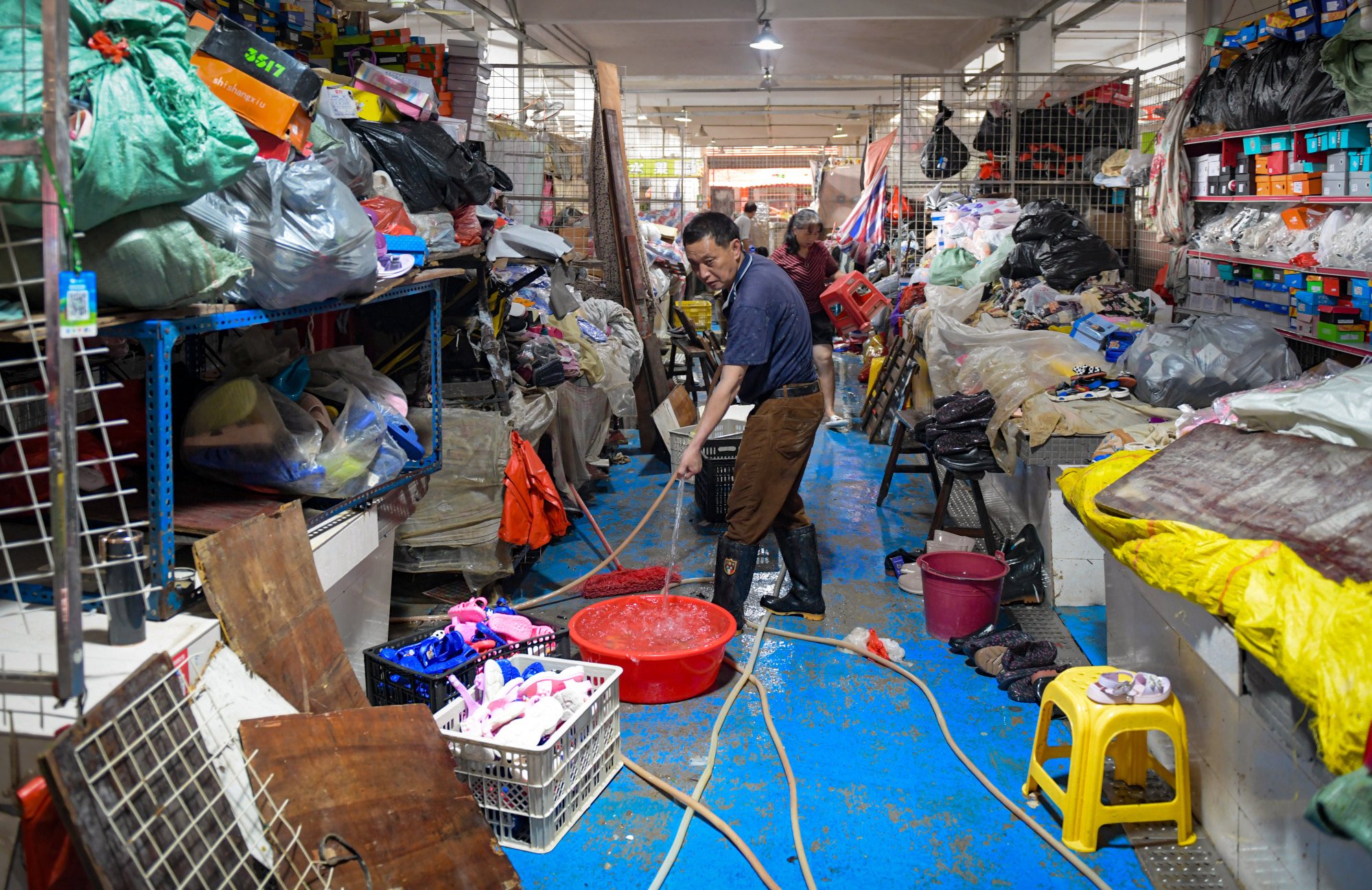 Residents of Longgui town in Guangdong province clean up their shops on Sunday after flooding. Photo: Xinhua