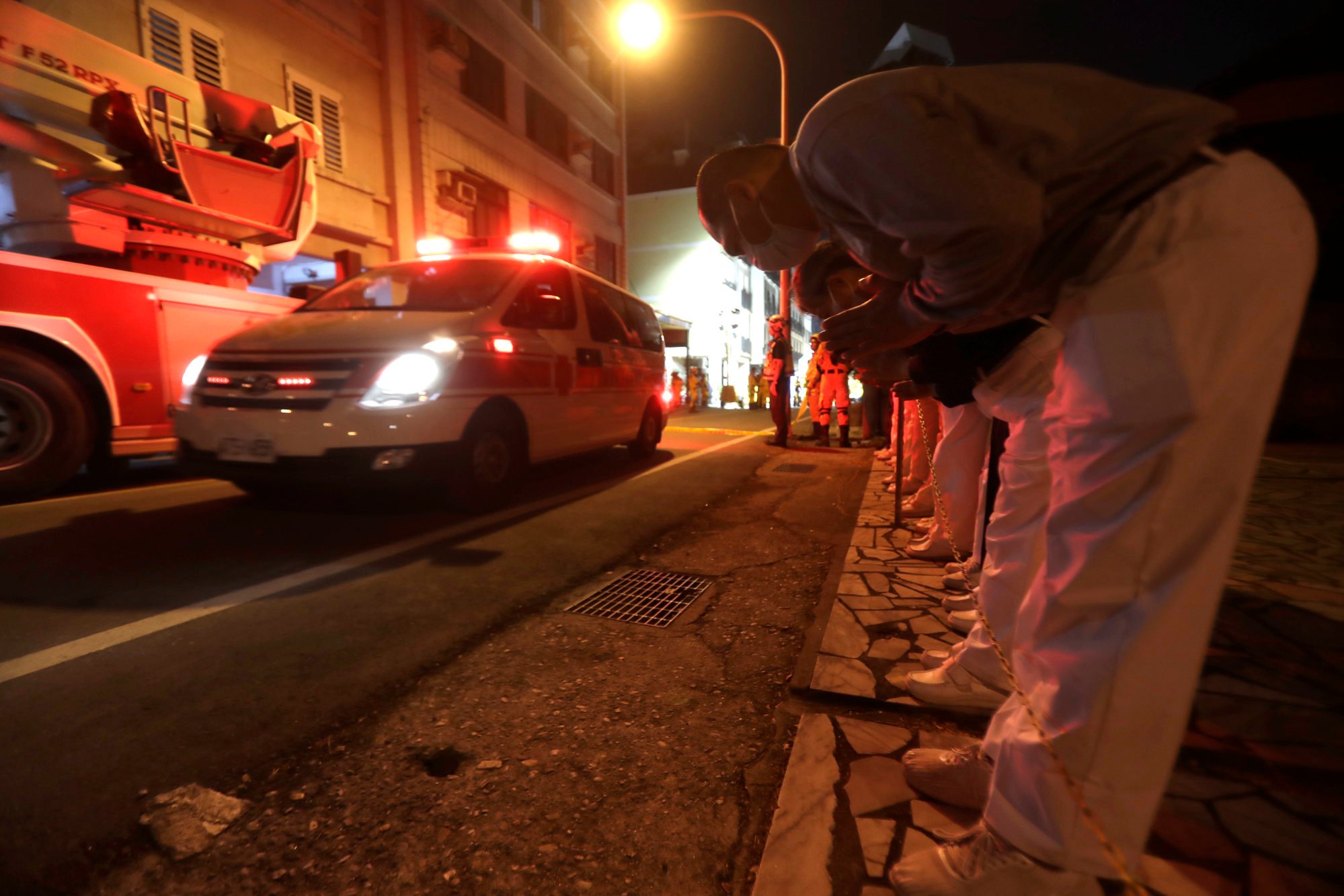 People pray for victims in a car during a rescue operation in Hualien after the earthquake on Wednesday. Photo: AP.