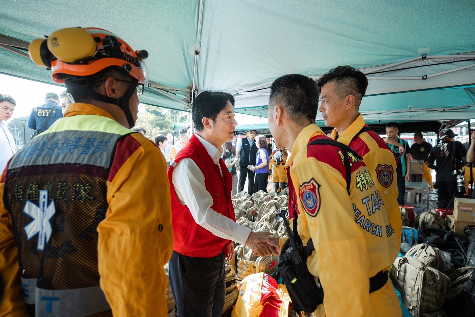 Taiwanese Vice-President William Lai Ching-te (centre) shakes hands with rescuers as he visits Hualien. Photo: Taiwan Presidential Office via AP