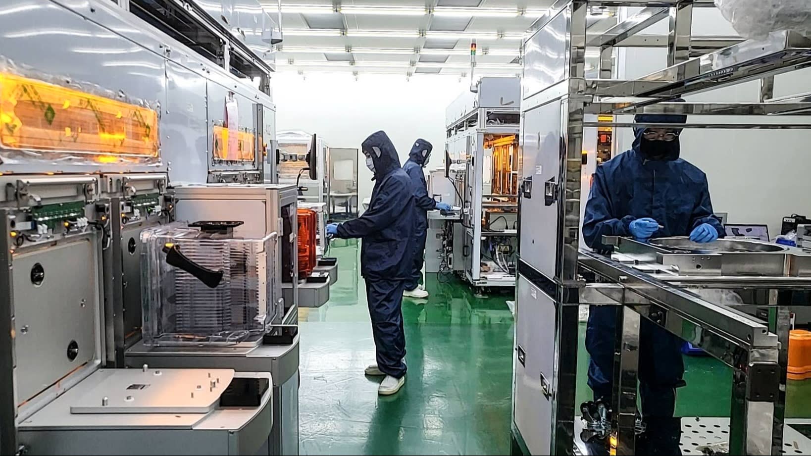 Workers in protective suits at a C Sun plant