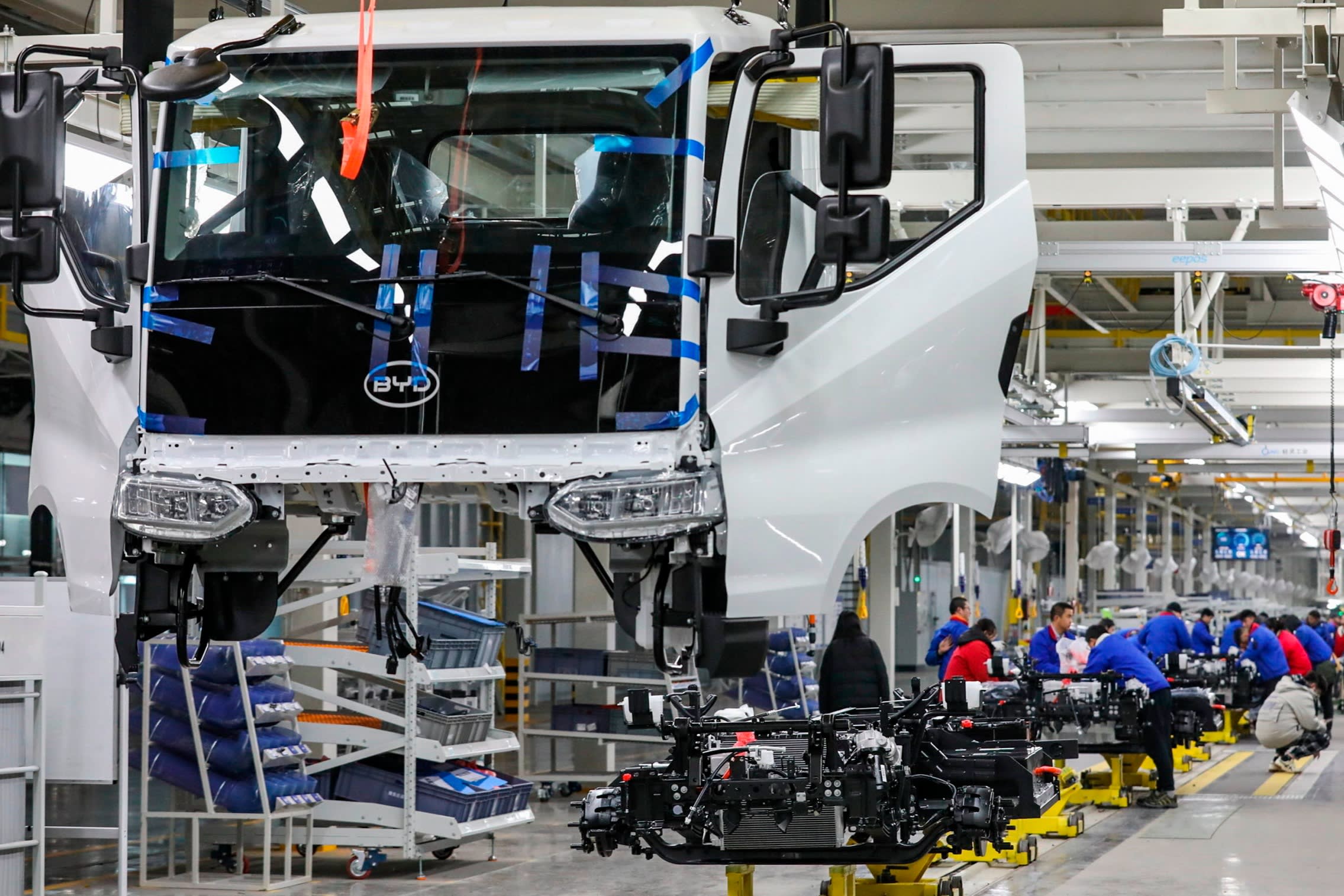 Workers assemble an electric truck at a BYD plan in Huai’an, China