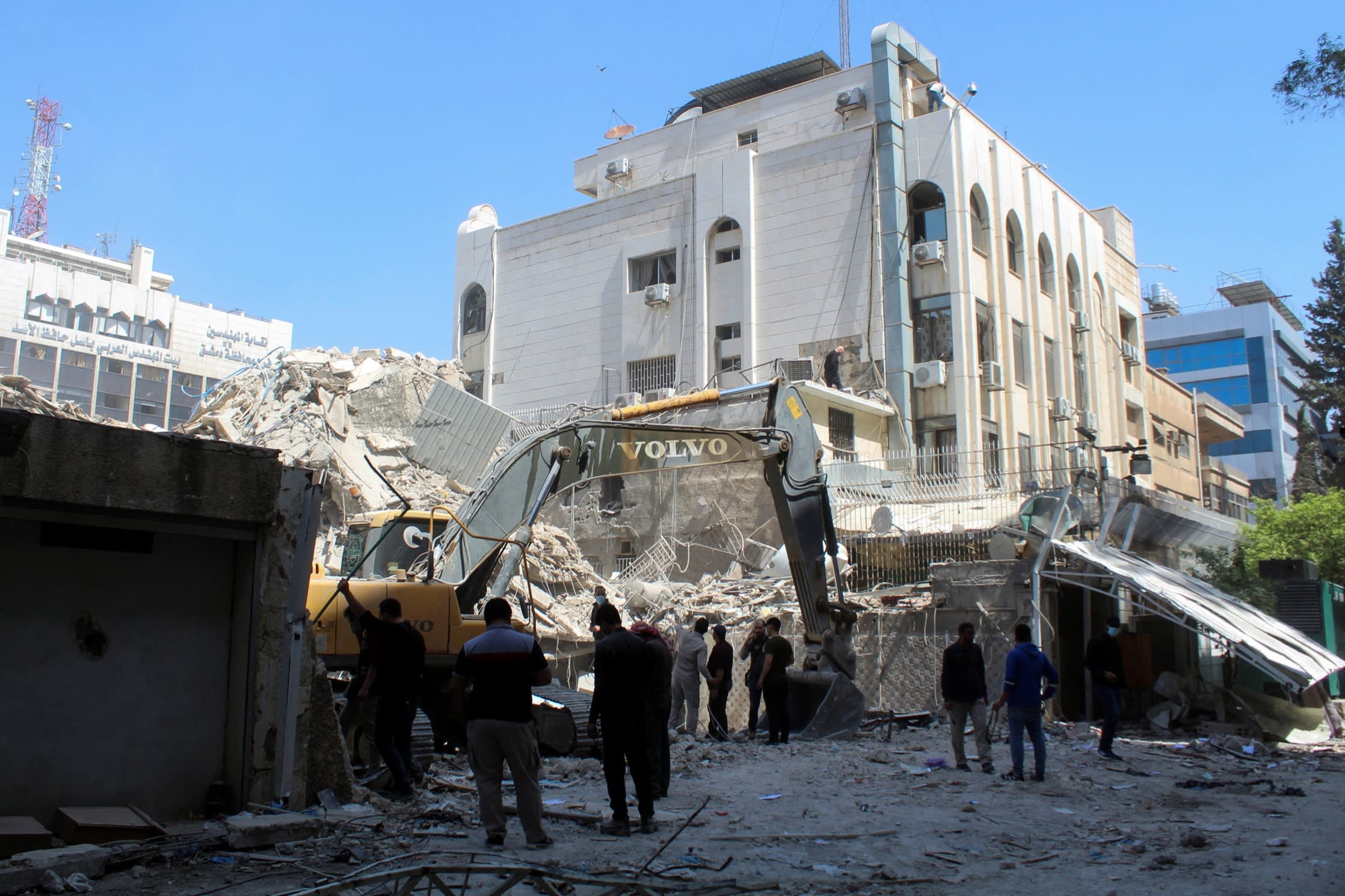 An excavator clears rubble after a suspected Israeli strike on Iran’s consulate in Damascus