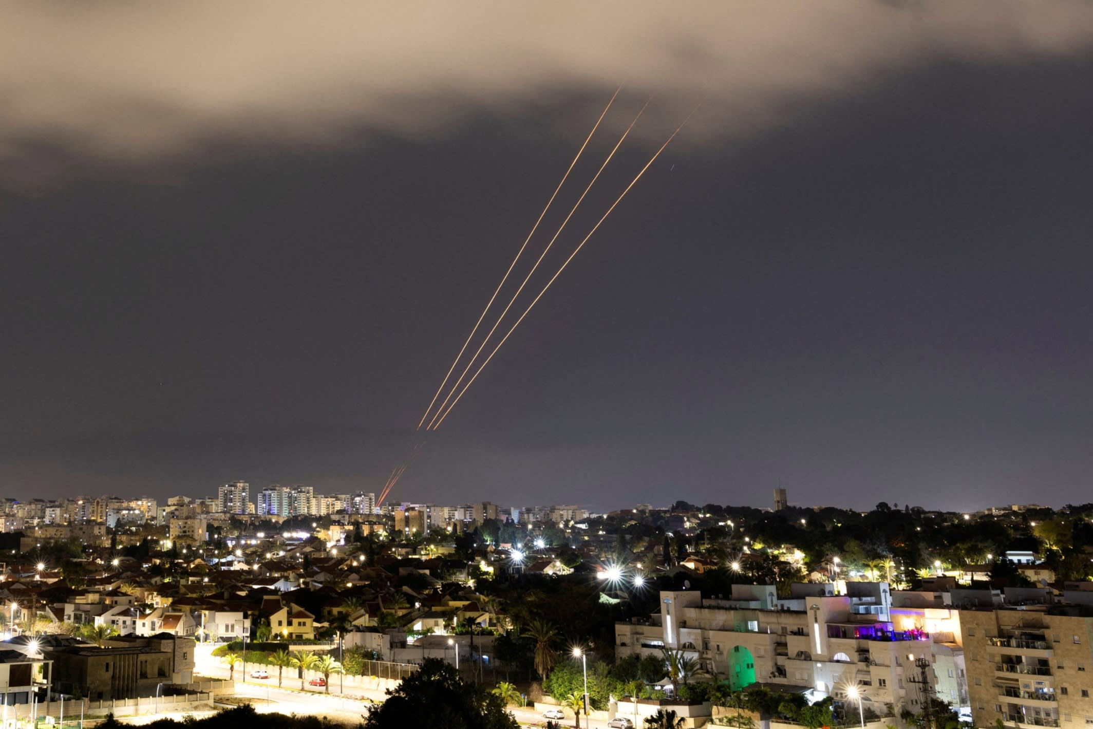An anti-missile system operates after Iran launched drones and missiles towards Israel