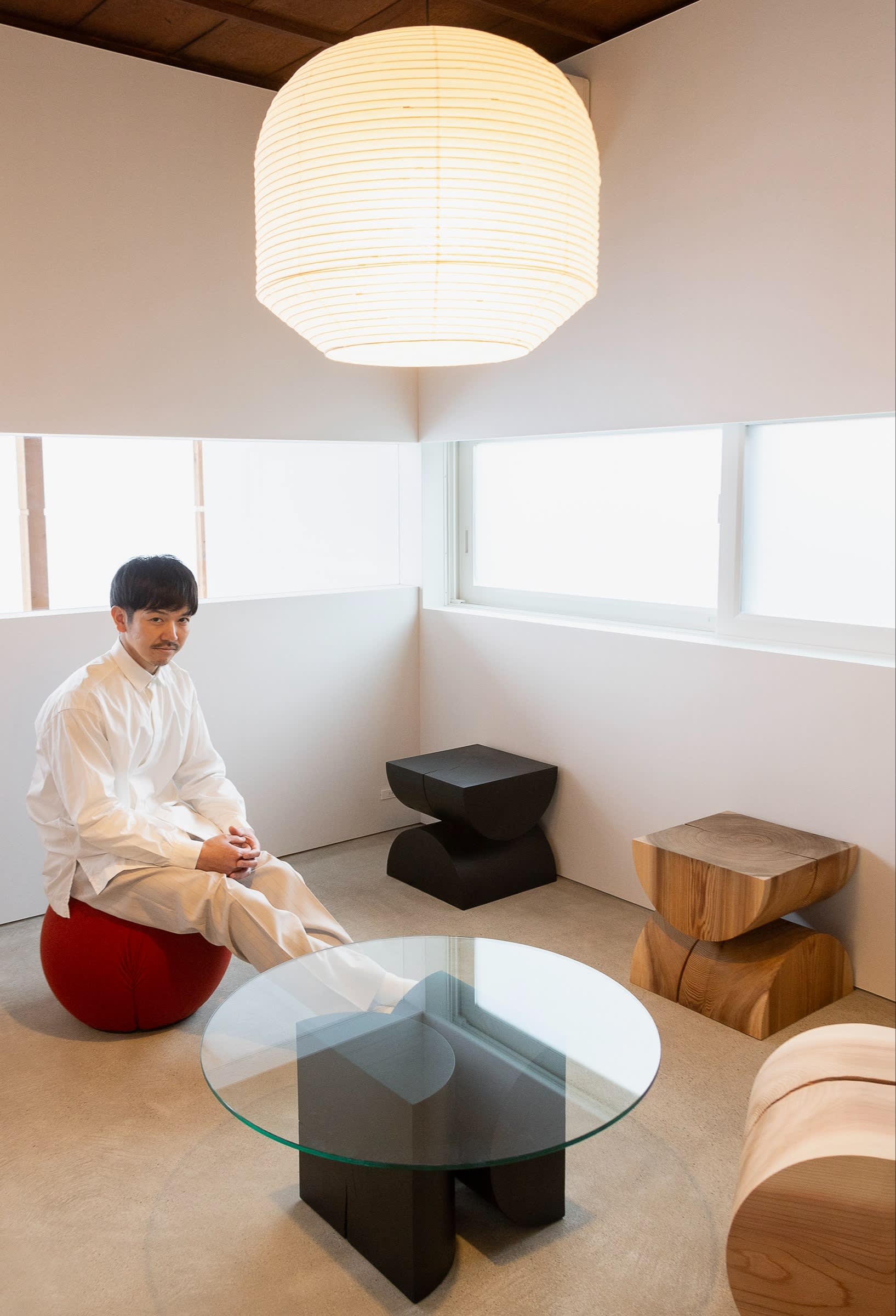 Kitada at home, surrounded by his wooden pieces