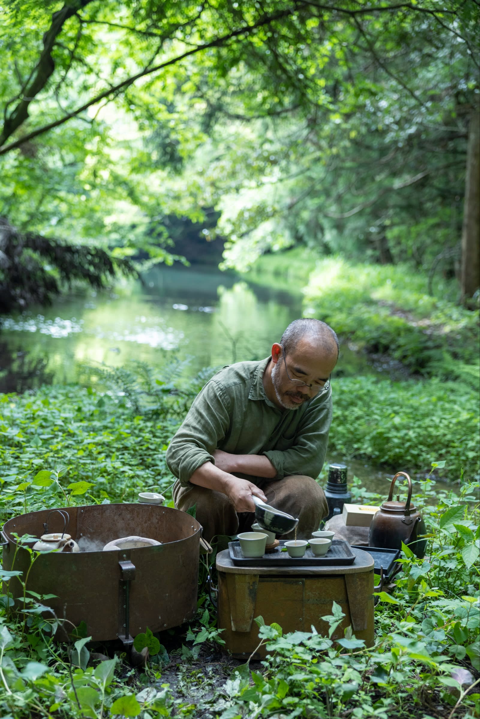 Takashi Ichikawa brews tea near a local pond