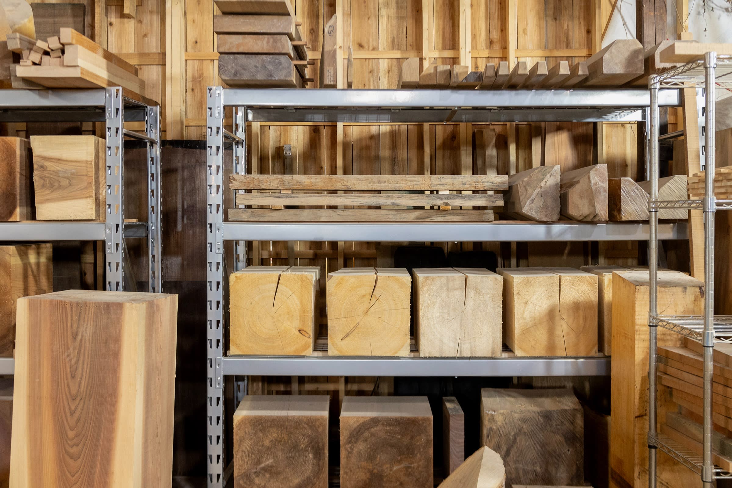 Partly cut logs stacked on shelves