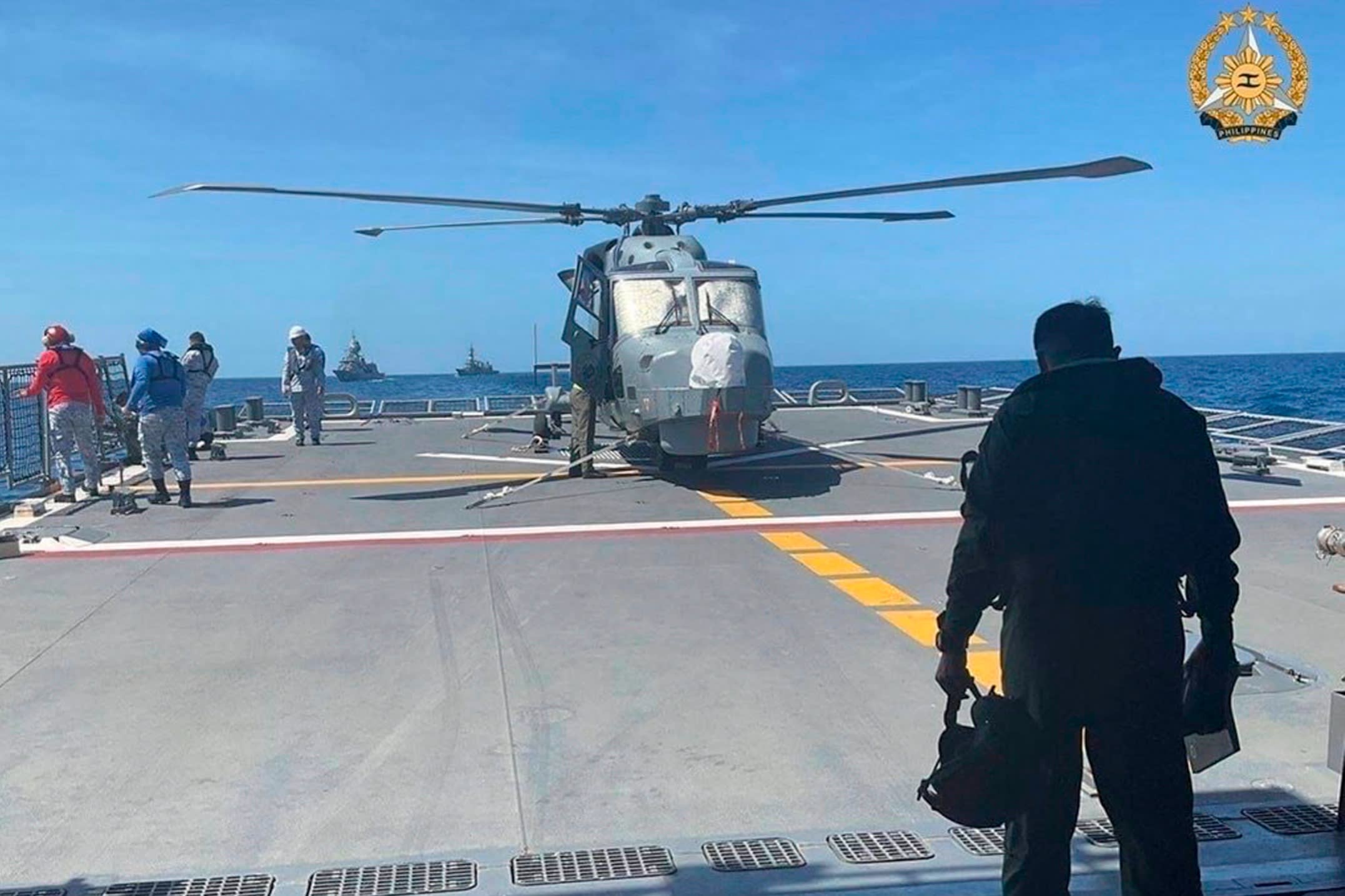 A Philippine Navy pilot arrives to board an AW159 Wildcat on board the Antonio Luna frigate during the first joint naval exercises between the US, Japan, Australia and the Philippines