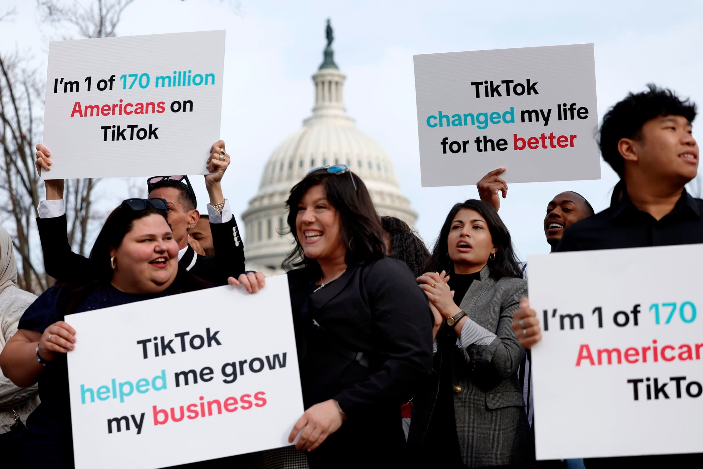 Participants hold signs in support of TikTok outside the US Capitol building