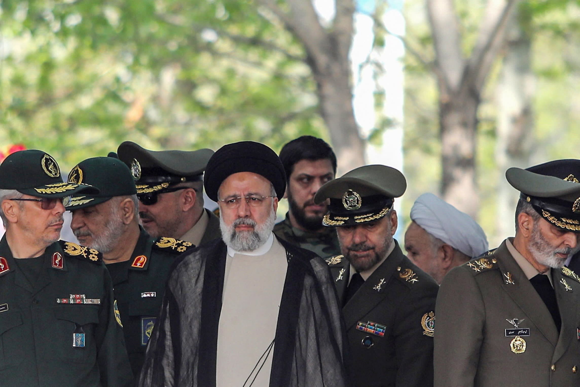 President Ebrahim Raisi surrounded by military personnel