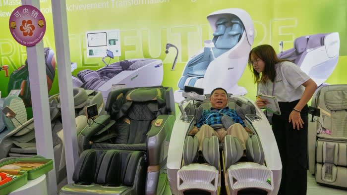 A customer tests a massage chair at the Canton Fair in Guangzhou