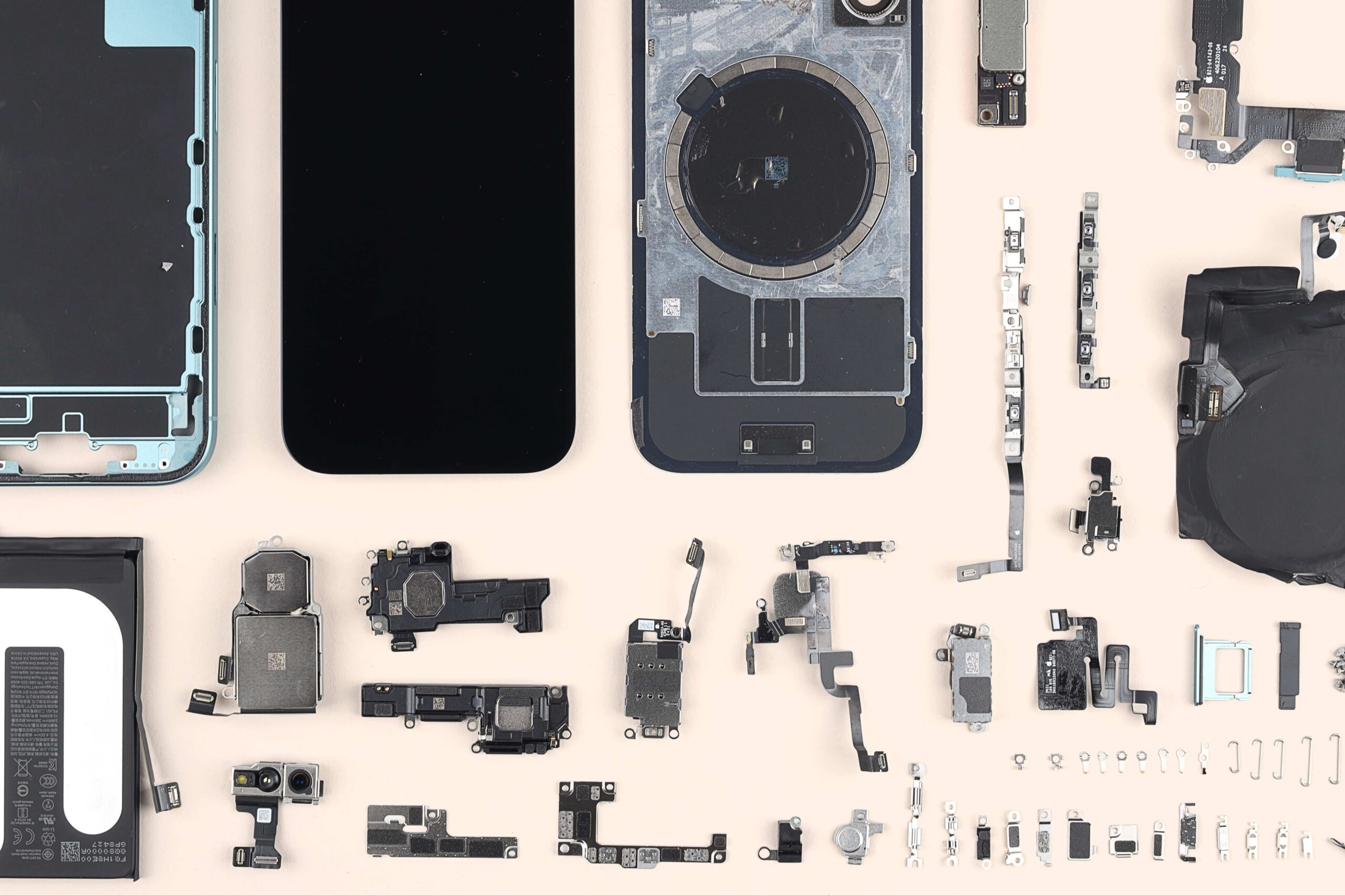 An exploded view of an iPhone 14 showing its internal components separated and laid out in 3D