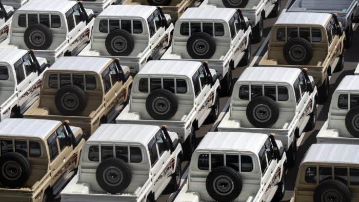 Toyota trucks await shipment are parked at a port in Yokohama, Japan