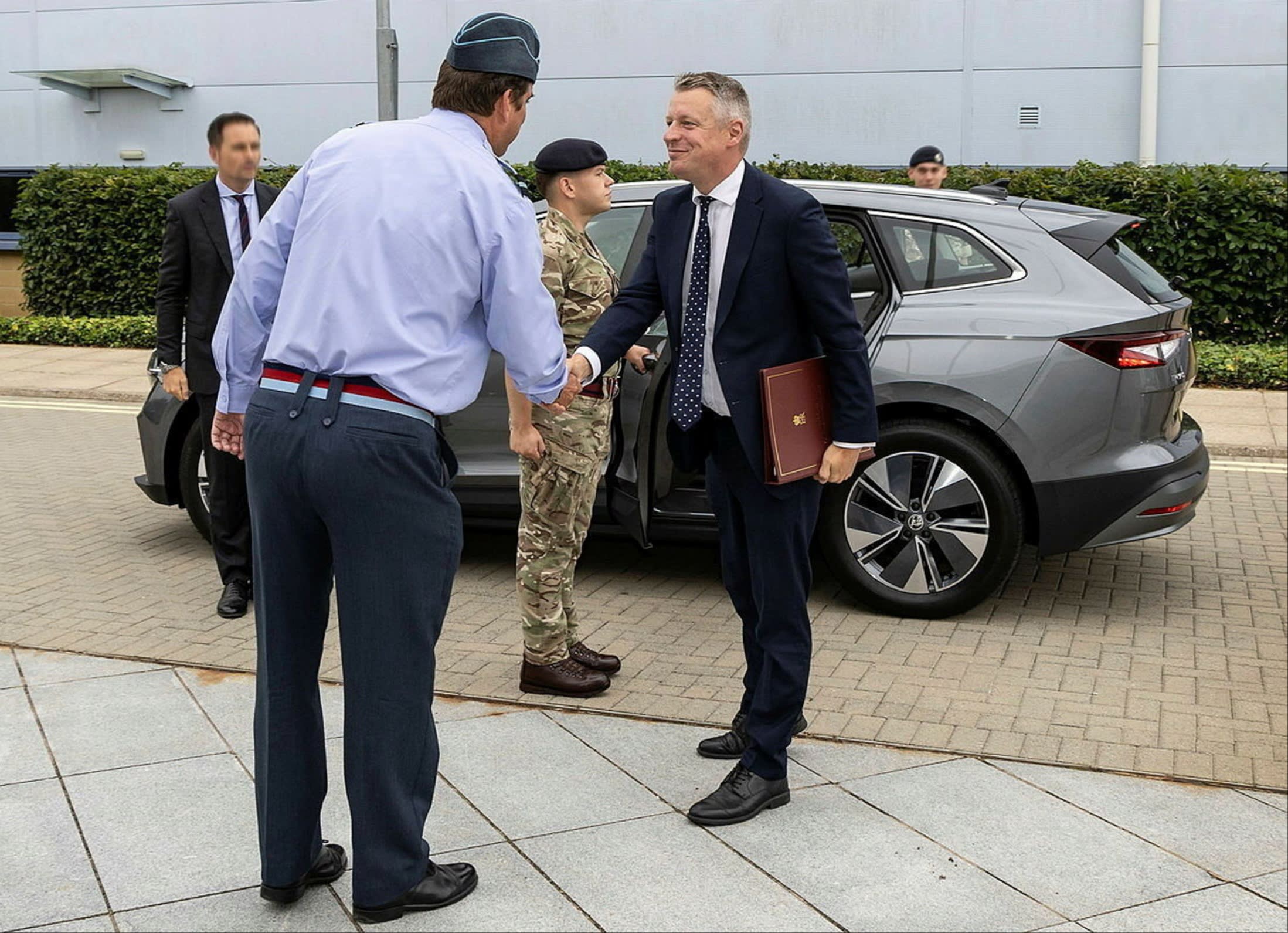 Armed forces minister Luke Pollard MP, centre, being greeted RAF Wyton last August — after arriving in an EV