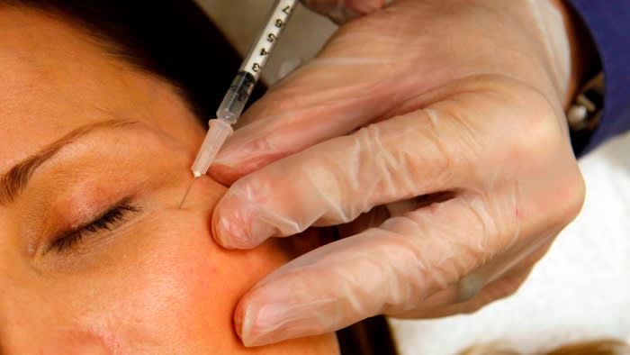 A woman has Botox injected