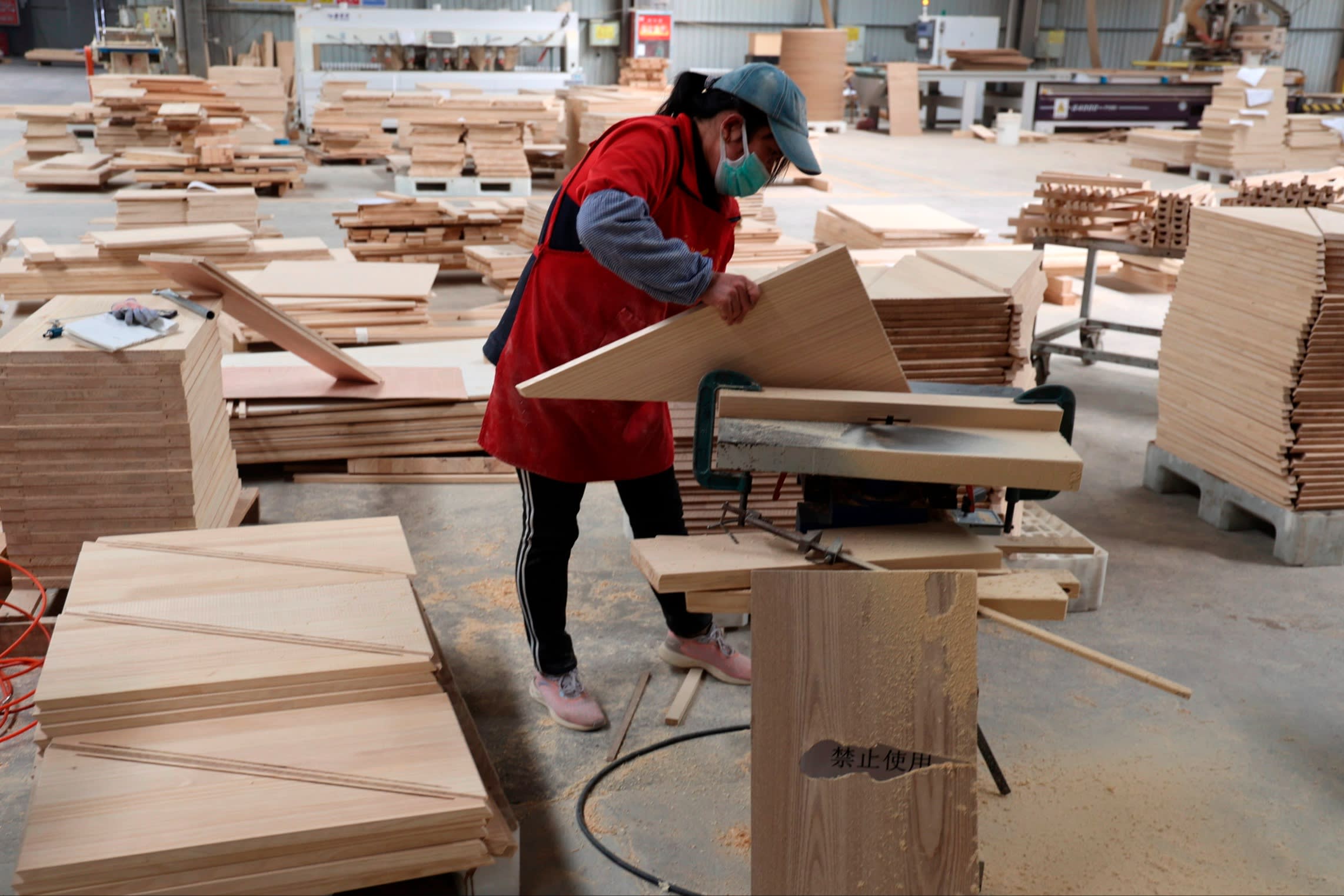 Person making wooden furniture
