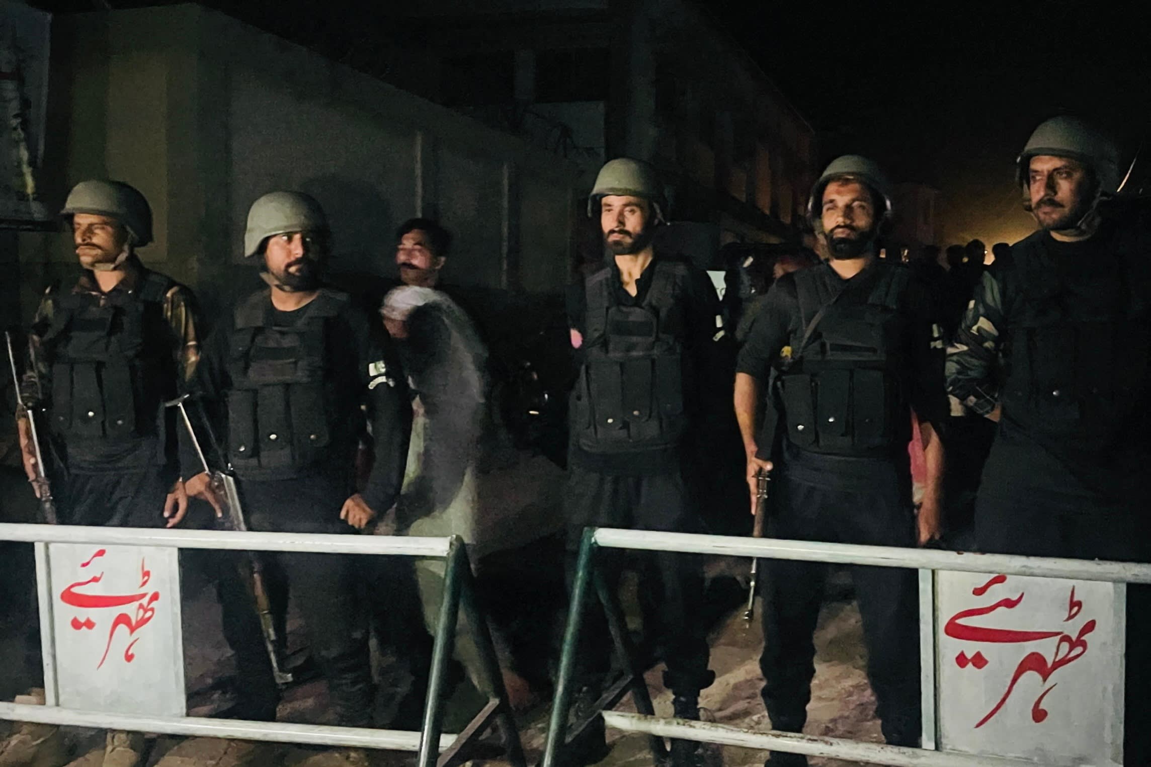 Security personnel cordon-off a street near the site of a strike in Muzaffarabad