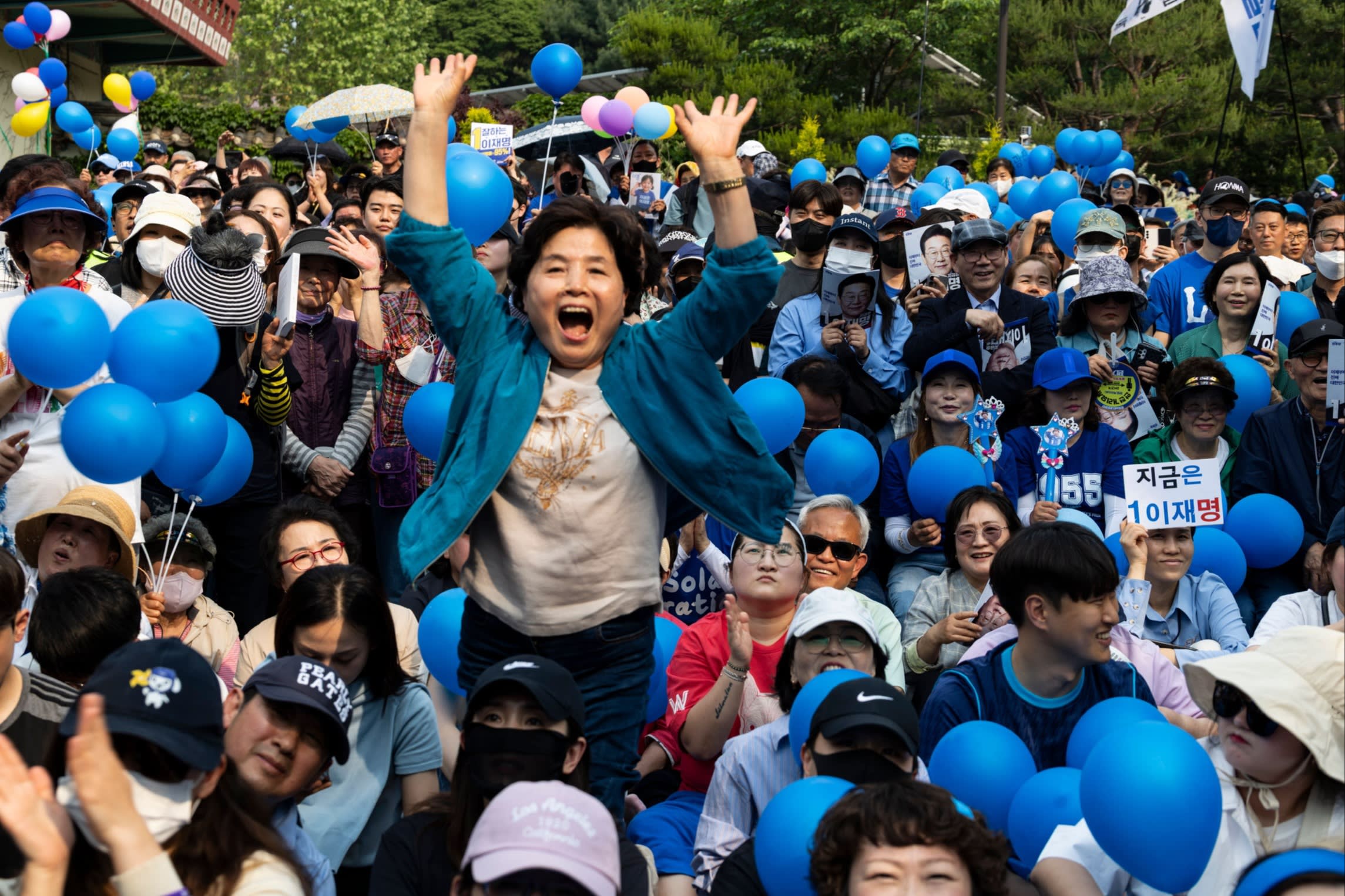 Supporters of presidential candidate of the Democratic Party Lee Jae-myung cheer during his election campaign