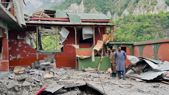 Soldiers inspect the debris of a mosque after Indian strikes in Muzaffarabad
