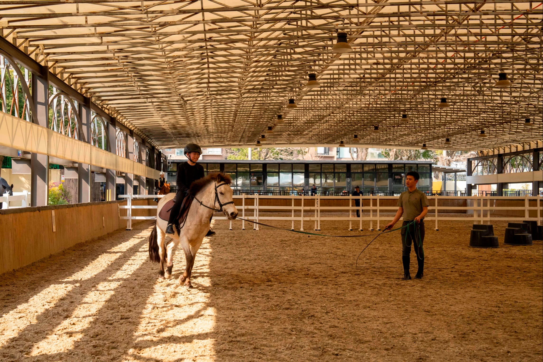 A novice rider rides a pony at the Shanghai YCL Riding Center in Shanghai, China