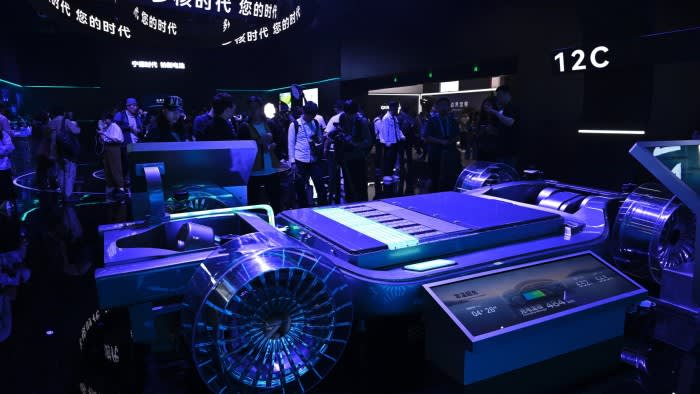 A model of CATL's second-generation Shenxing superfast charging battery is displayed on a platform surrounded by a crowd