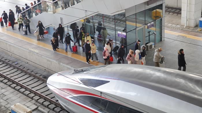 Passengers take a train at Yantai Station in China’s eastern Shandong province