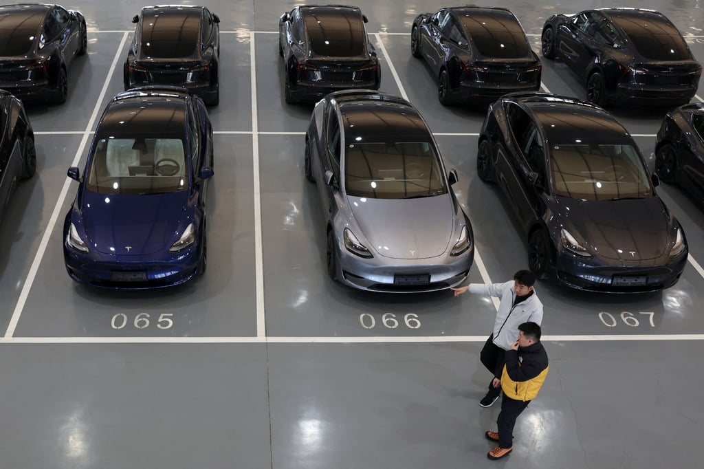 People walk past Tesla electric vehicles at the carmaker’s delivery centre in Beijing in January. Unique EV features like regenerative braking systems can induce motion sickness, according to researchers. Photo: Reuters People walk past Tesla electric vehicles at the carmaker’s delivery centre in Beijing in January. Unique EV features like regenerative braking systems can induce motion sickness, according to researchers. Photo: Reuters