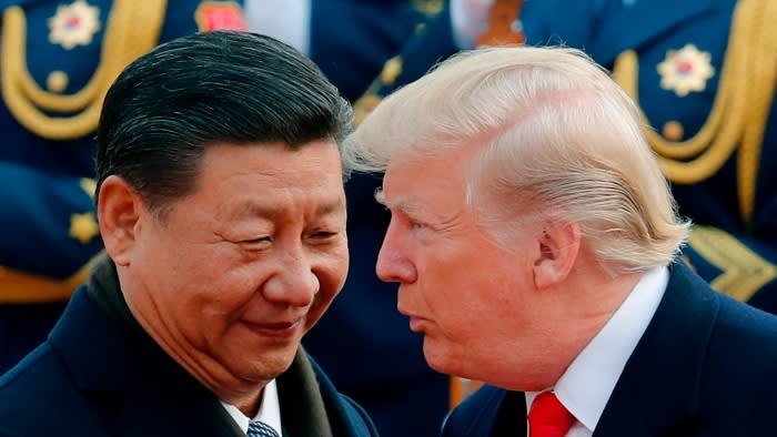 Close up of Donald Trump leaning over to talk to Xi Jinping