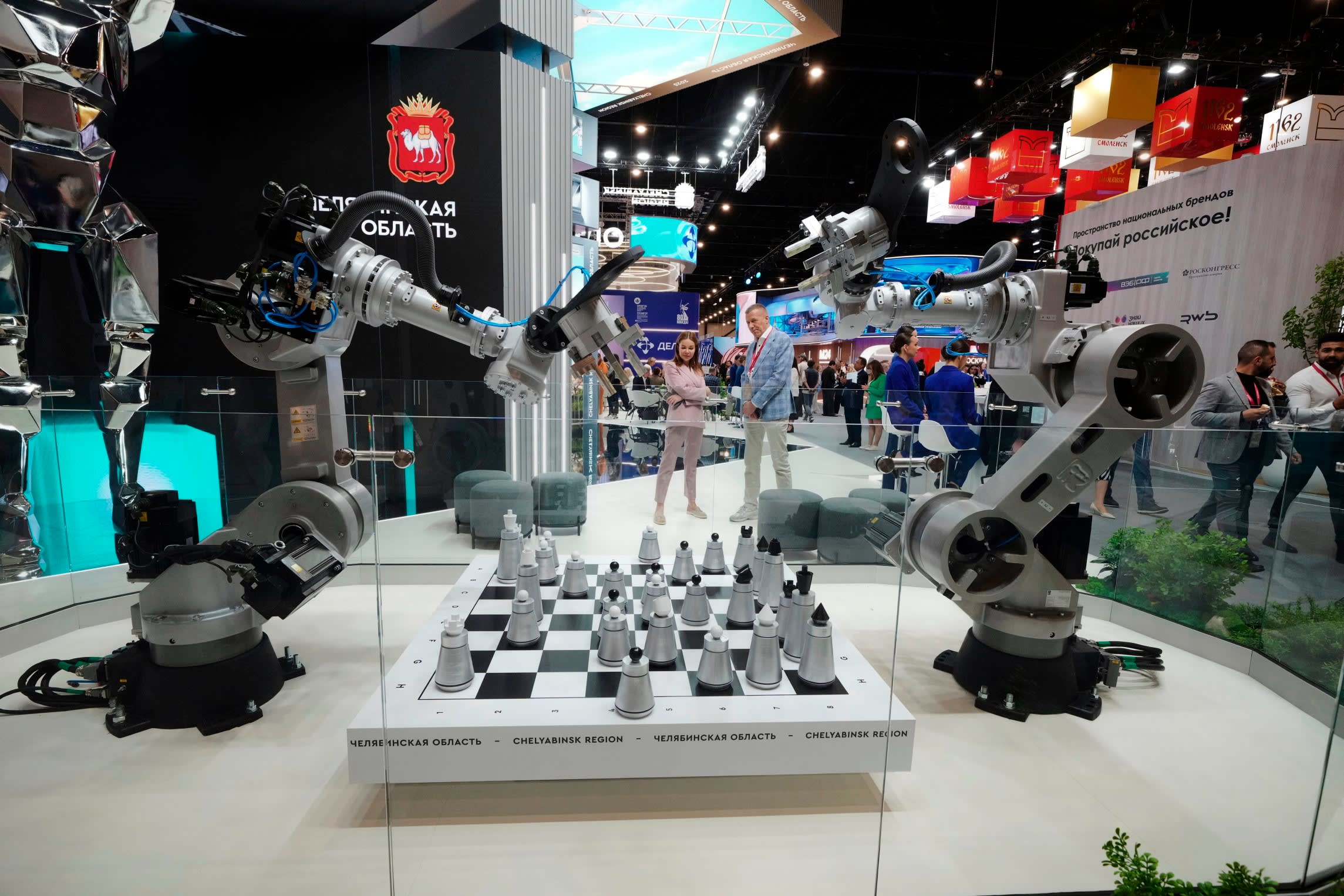 Visitors look at an exhibition on the sidelines of the St Petersburg International Economic Forum