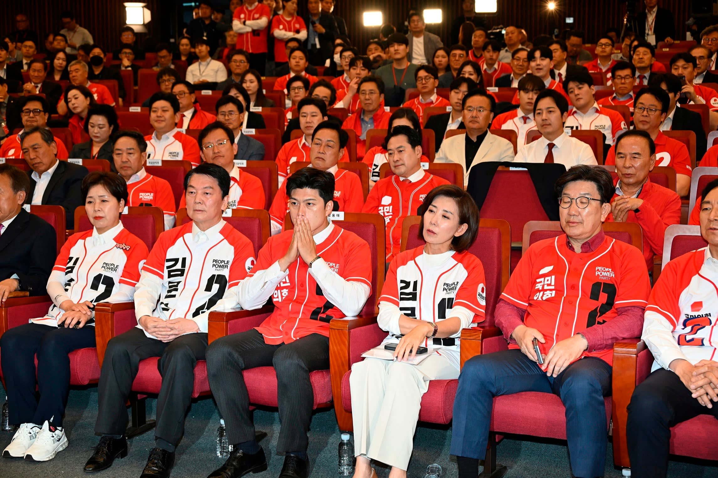 Members of the People Power party react as they watch a television report on exit polls for South Korea’s presidential election.