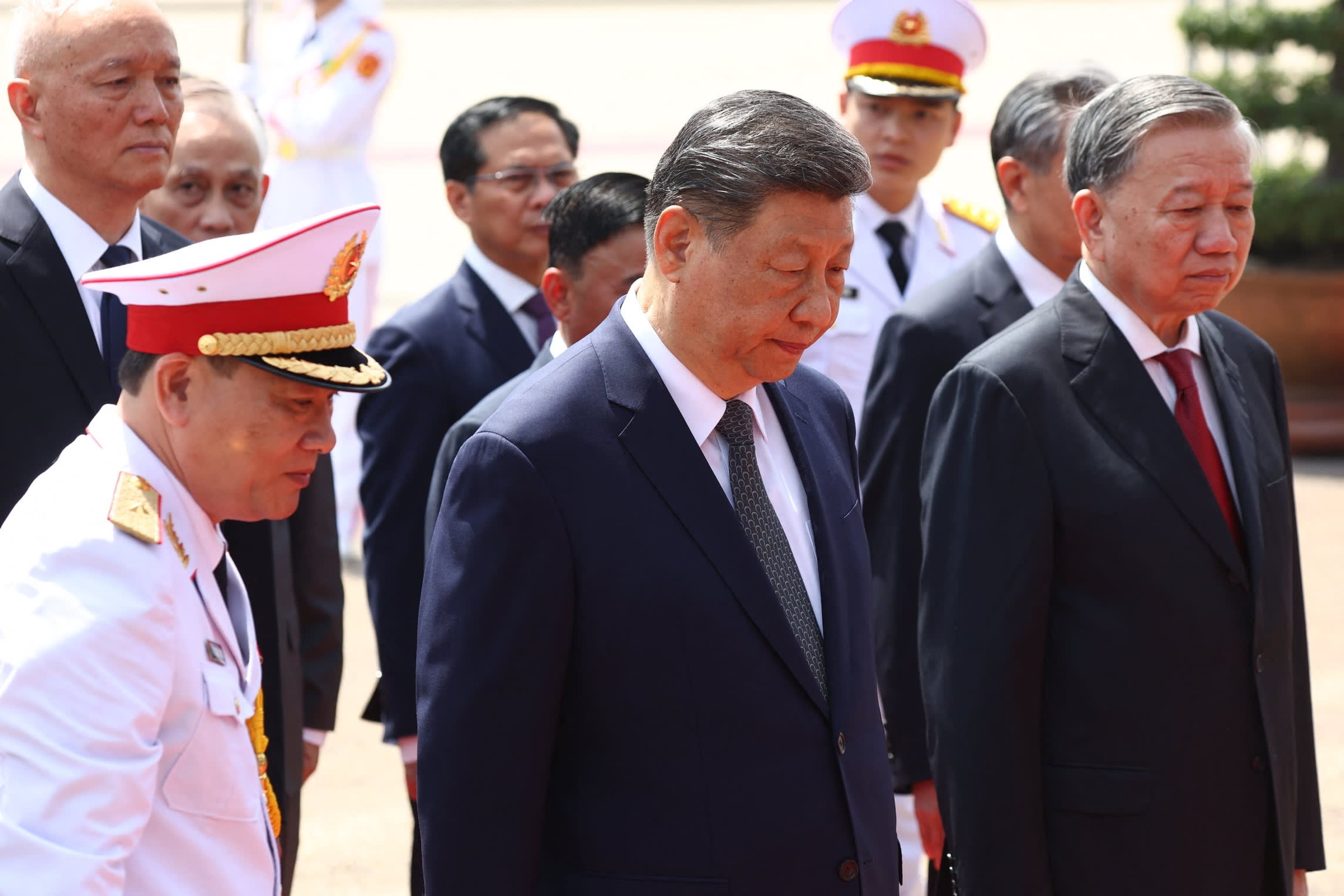 Chinese President Xi Jinping walks with Vietnam’s Communist Party General Secretary To Lam