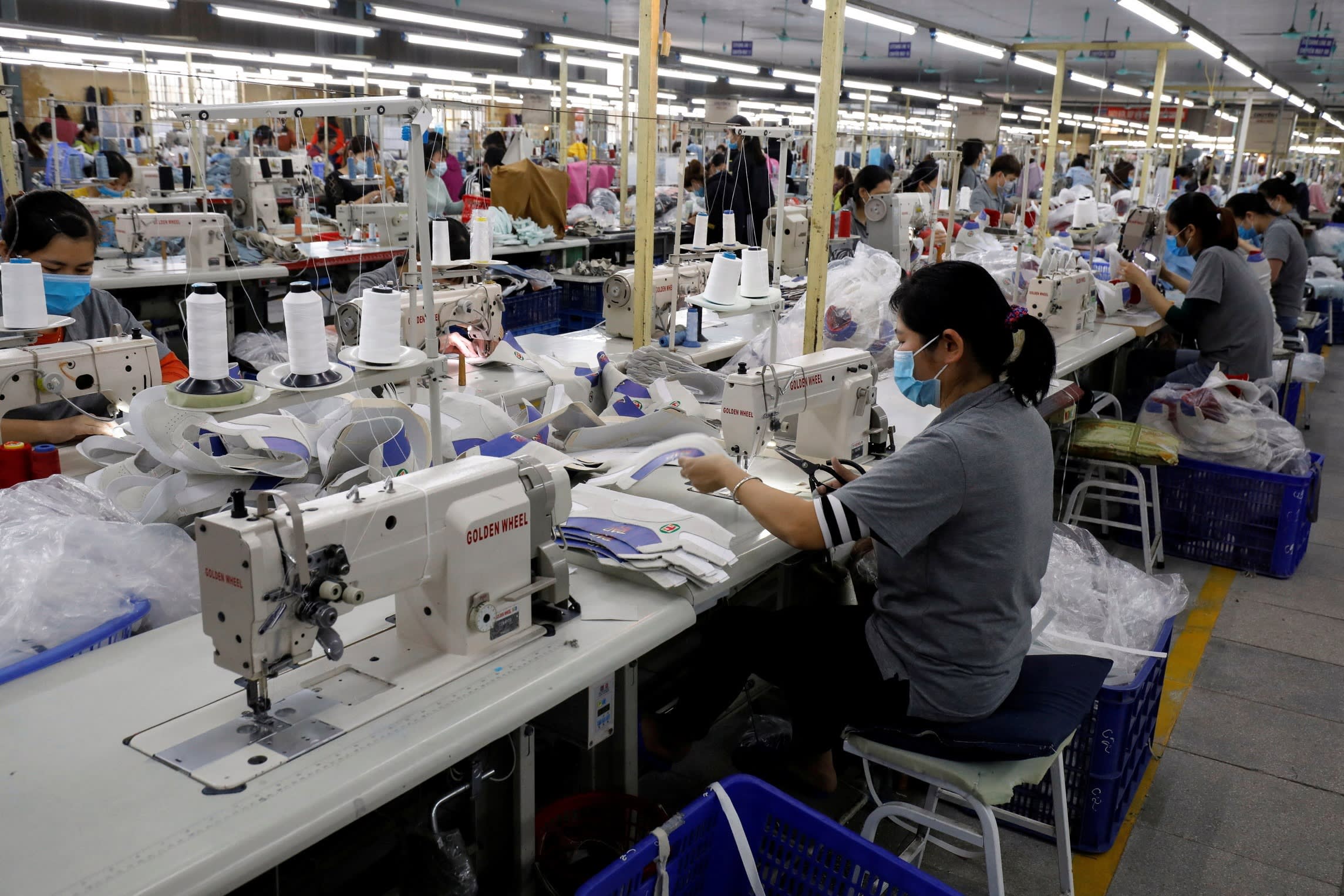Employees work at a shoe factory for export in Hanoi