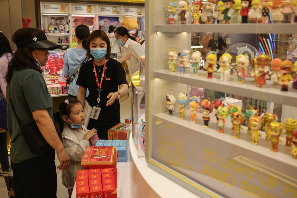 A girl looked at “blind boxes” - where their contents are hidden by sealed packaging - at a Pop Mart store in Beijing on June 3 2021. Photo: EPA-EFE A girl looked at “blind boxes” - where their contents are hidden by sealed packaging - at a Pop Mart store in Beijing on June 3 2021. Photo: EPA-EFE