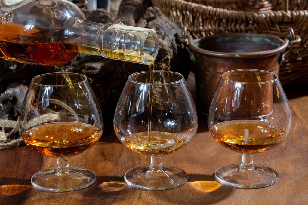 Tasting glasses of aged French cognac brandy are poured in France. Photo: Shutterstock Tasting glasses of aged French cognac brandy are poured in France. Photo: Shutterstock