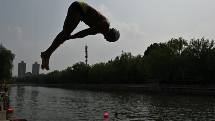 A man dives in the Longtan during a heatwave in Beijing on July 11, 2025