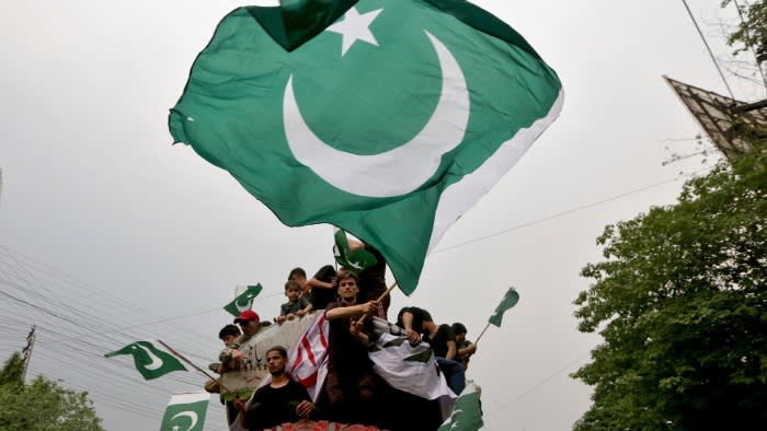 People waving Pakistan flags