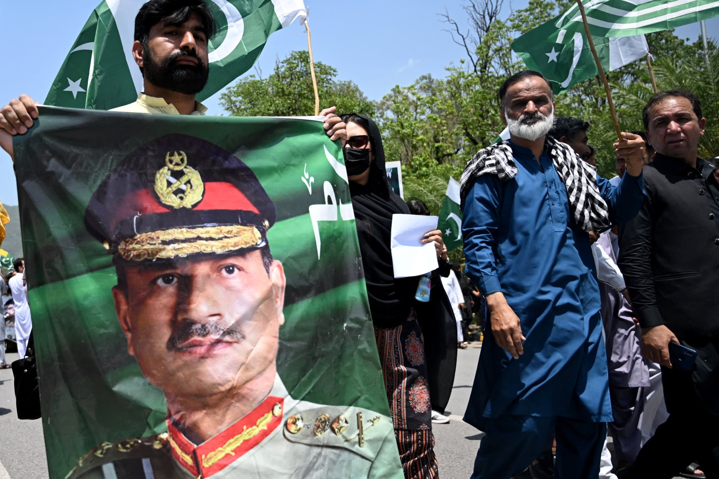 A man carries a portrait of Pakistani Army Chief General Syed Asim Munir, during a rally to express solidarity with Pakistan’s armed forces, in Islamabad on May 14, 2025