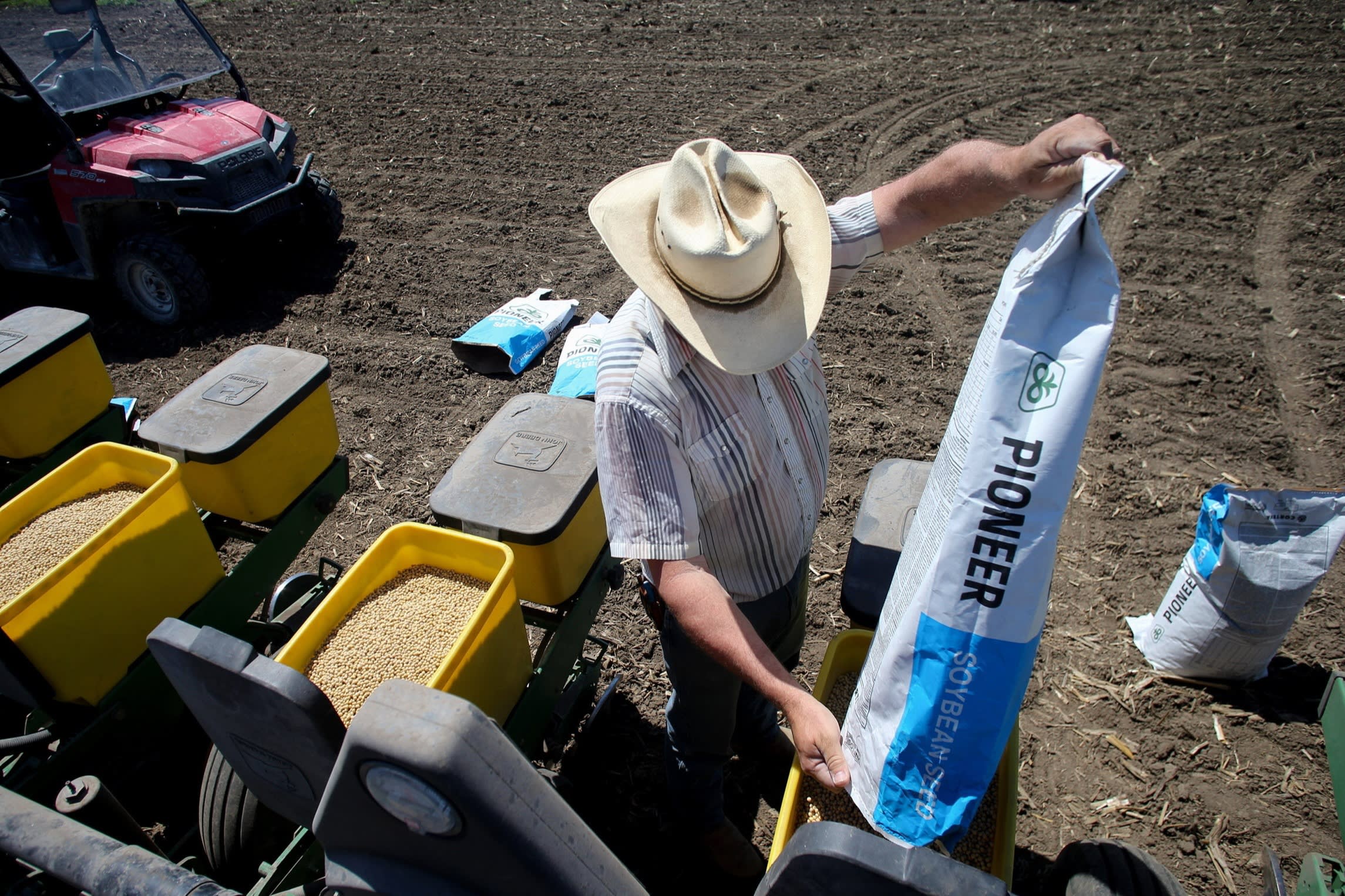 A worker prepares soyabeans for planting at Double G Angus Farms in Tiffin, Iowa