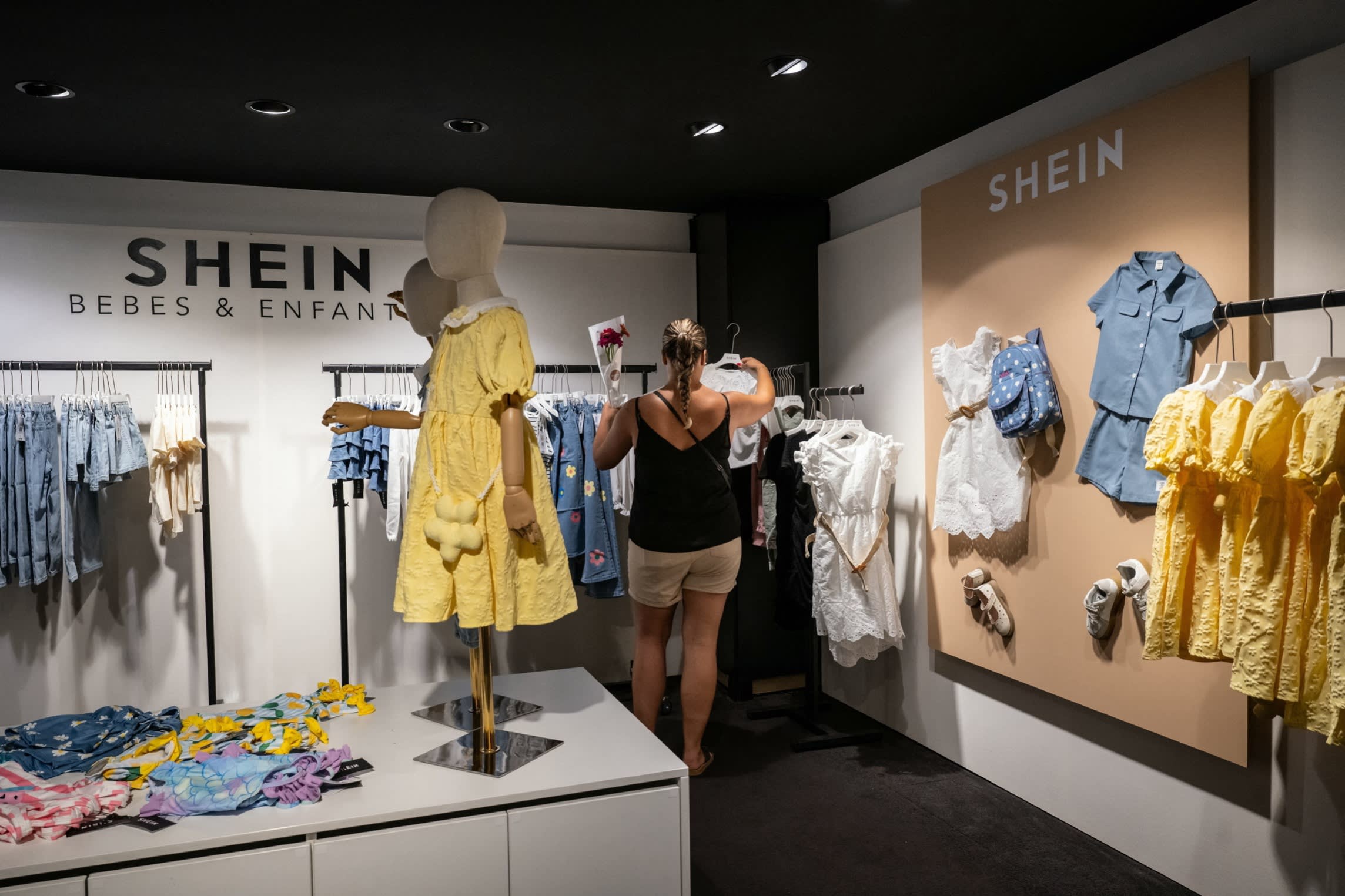 A customer looks at clothes in a Shein pop-up store in Dijon, France on June 26 2025