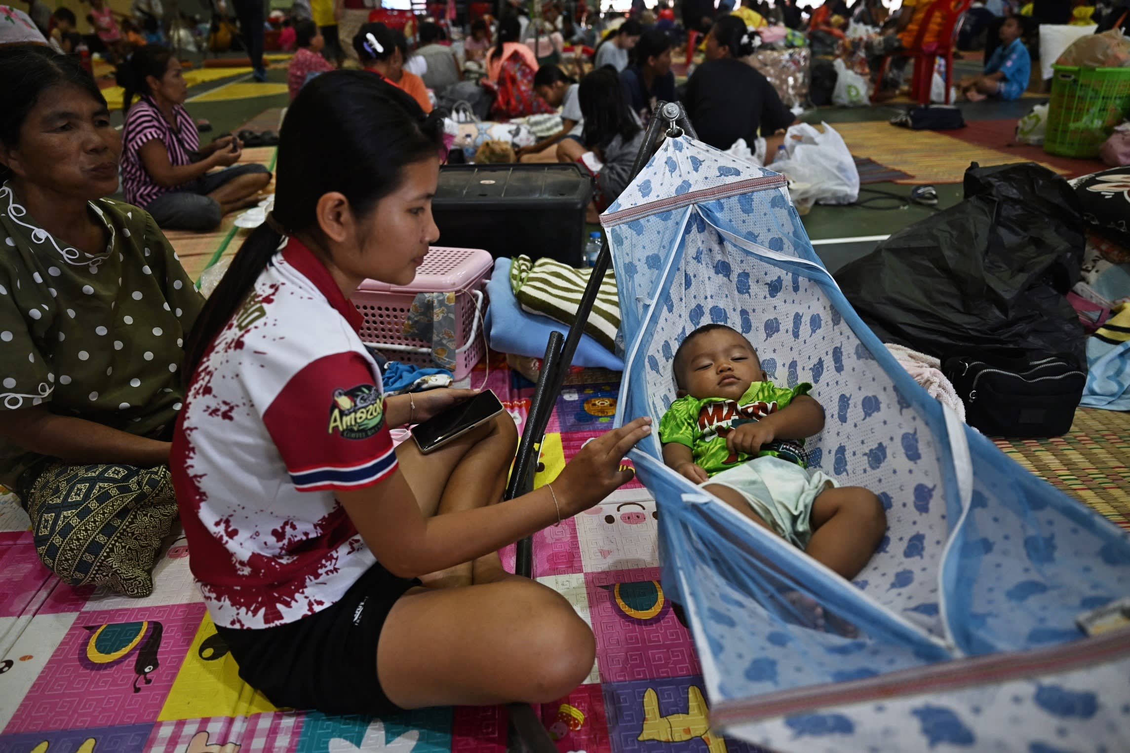 Evacuees take shelter in a gymnasium at Surindra Rajabhat University in Thailand’s Surin province on Friday