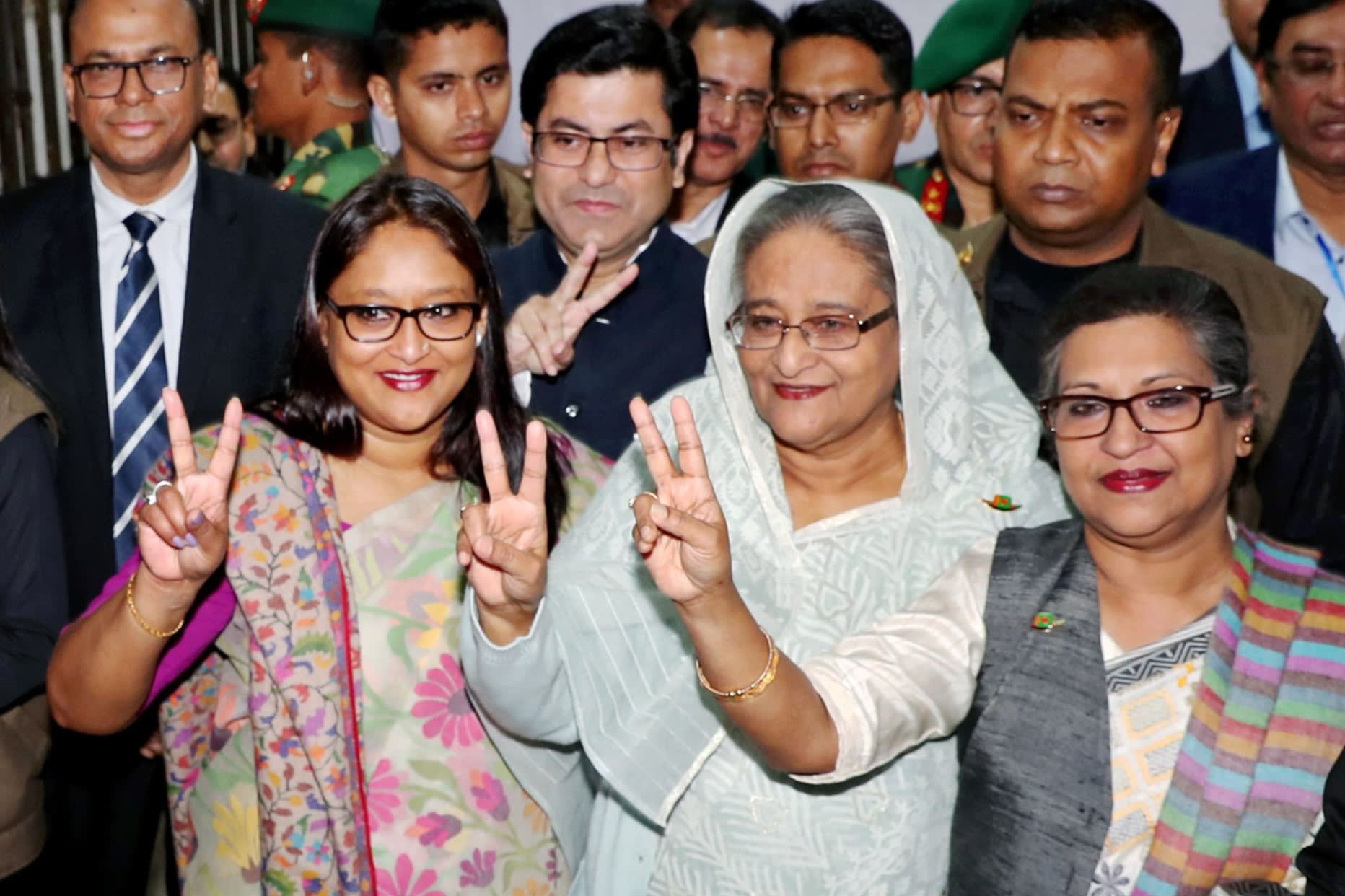 Former Bangladeshi Prime Minister Sheikh Hasina (C), flanked by her daughter Saima Wazed (L) and sister Sheikh Rehana (R)