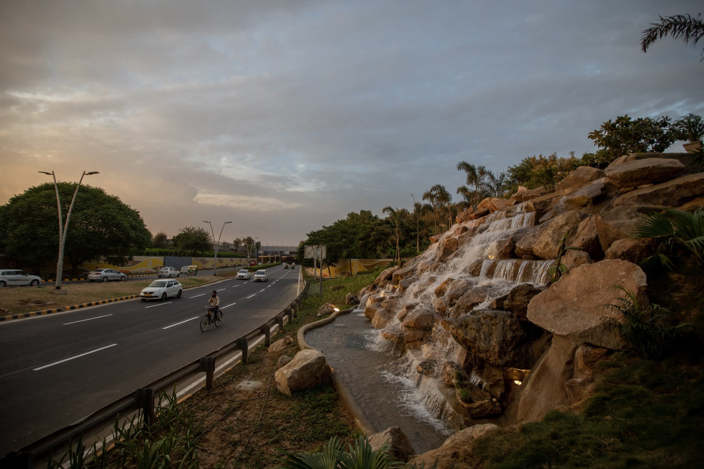 A manmade waterfall next to a highway
