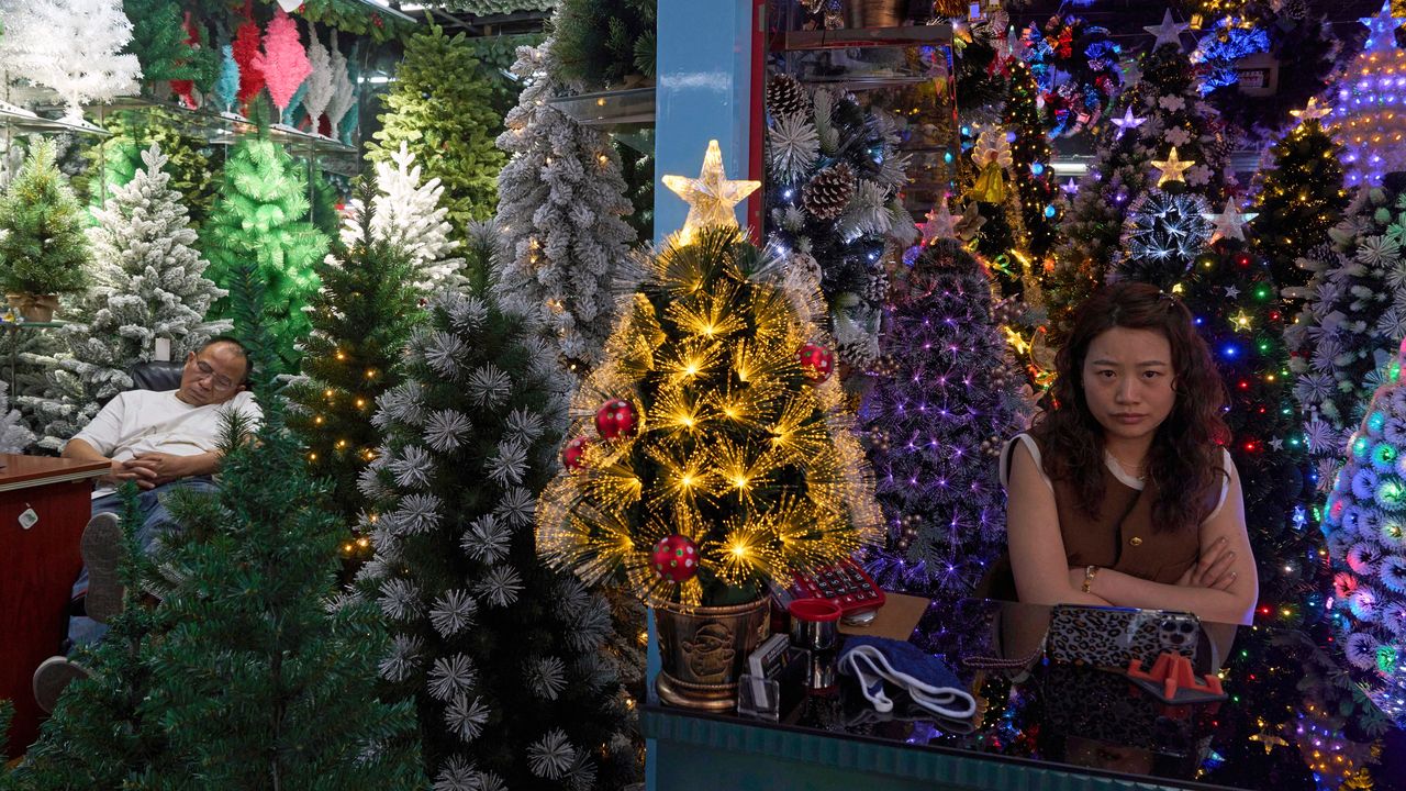 Vendors wait for customers at Christmas tree store at the Yiwu International Trade Market.