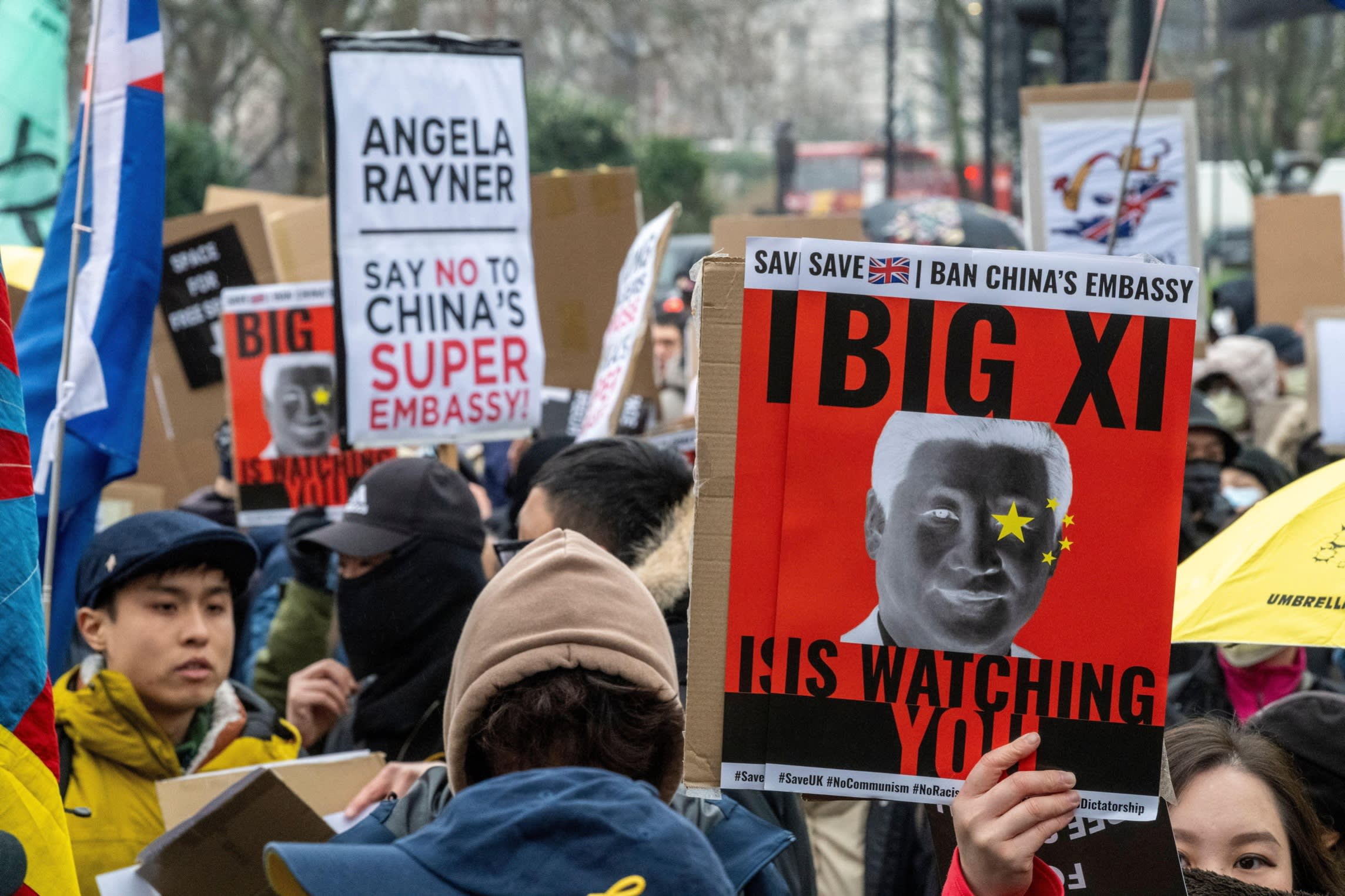 Protesters hold signs reading “Angela Rayner Say No to China’s Super Embassy” and “Big Xi Is Watching You” during a demonstration.