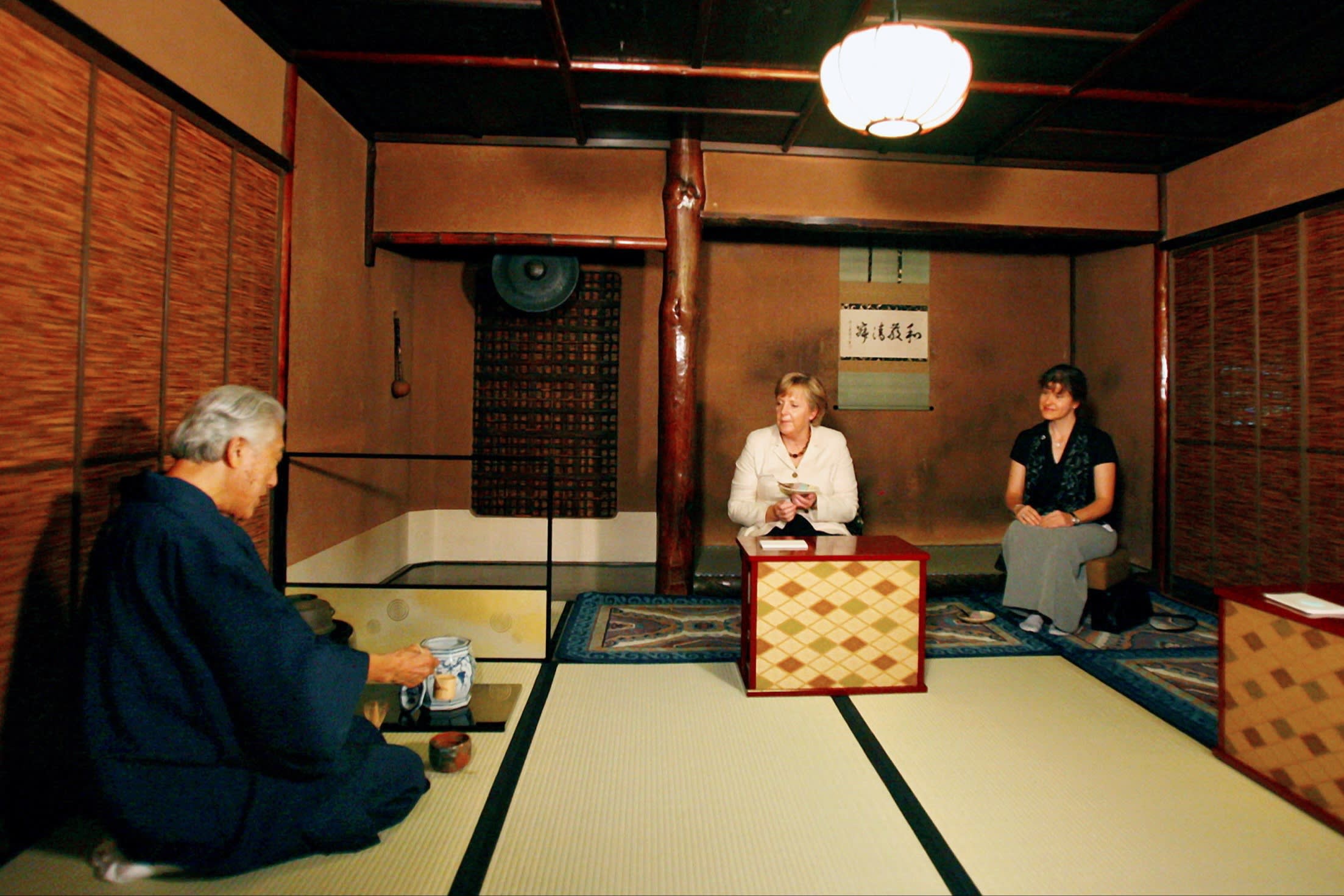 Angela Merkel is served tea by Genshitsu Sen during a Japanese tea ceremony