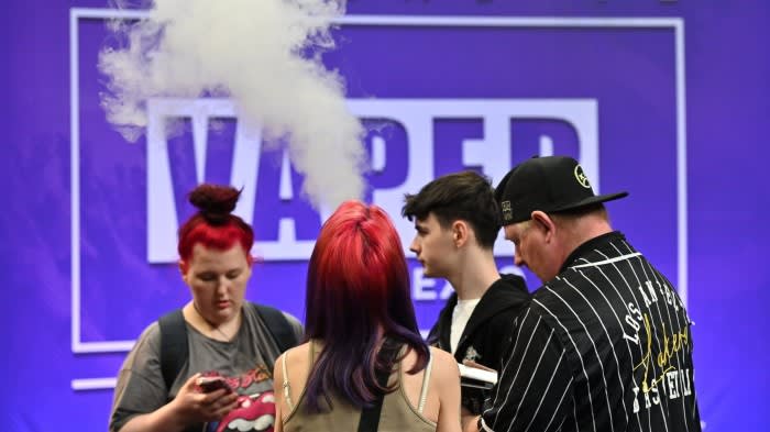 Visitors in front of the Vaper Expo sign at the NEC in Birmingham, England in May 2024